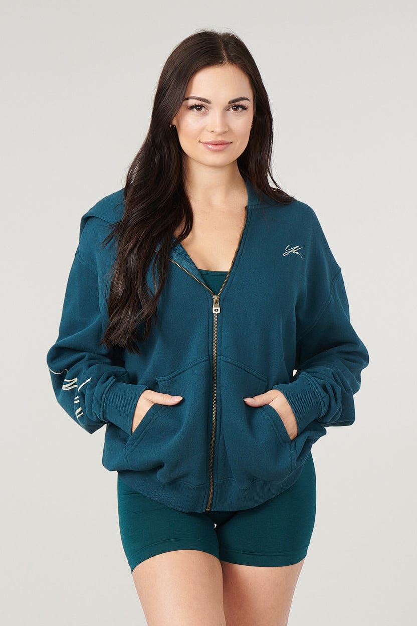 Model showcasing the relaxed fit of the black zip up hoodie.