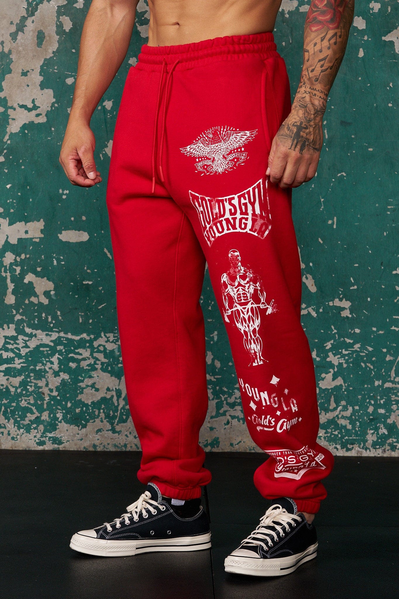 Close-up of Golds Gym logo detail on black cuffed joggers