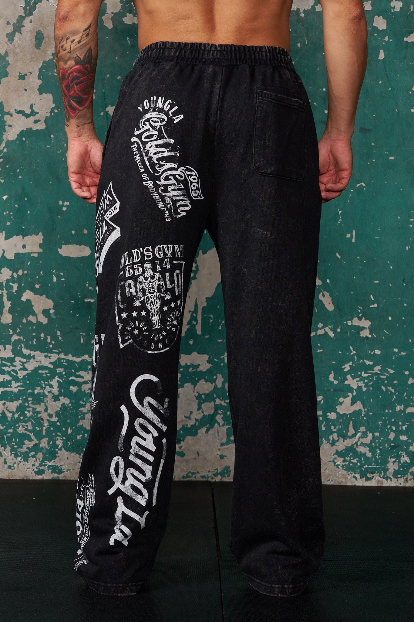 Side view of baggy grey sweatpants with YoungLA logo, perfect for gym wear.