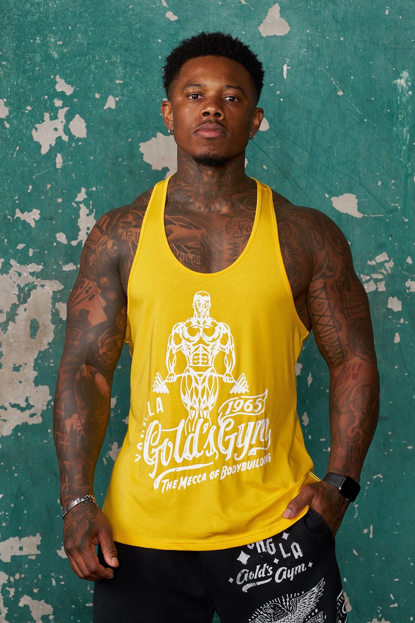 Front view of Gold's Gym Modern Fit Stringer Tank Top in workout setting.