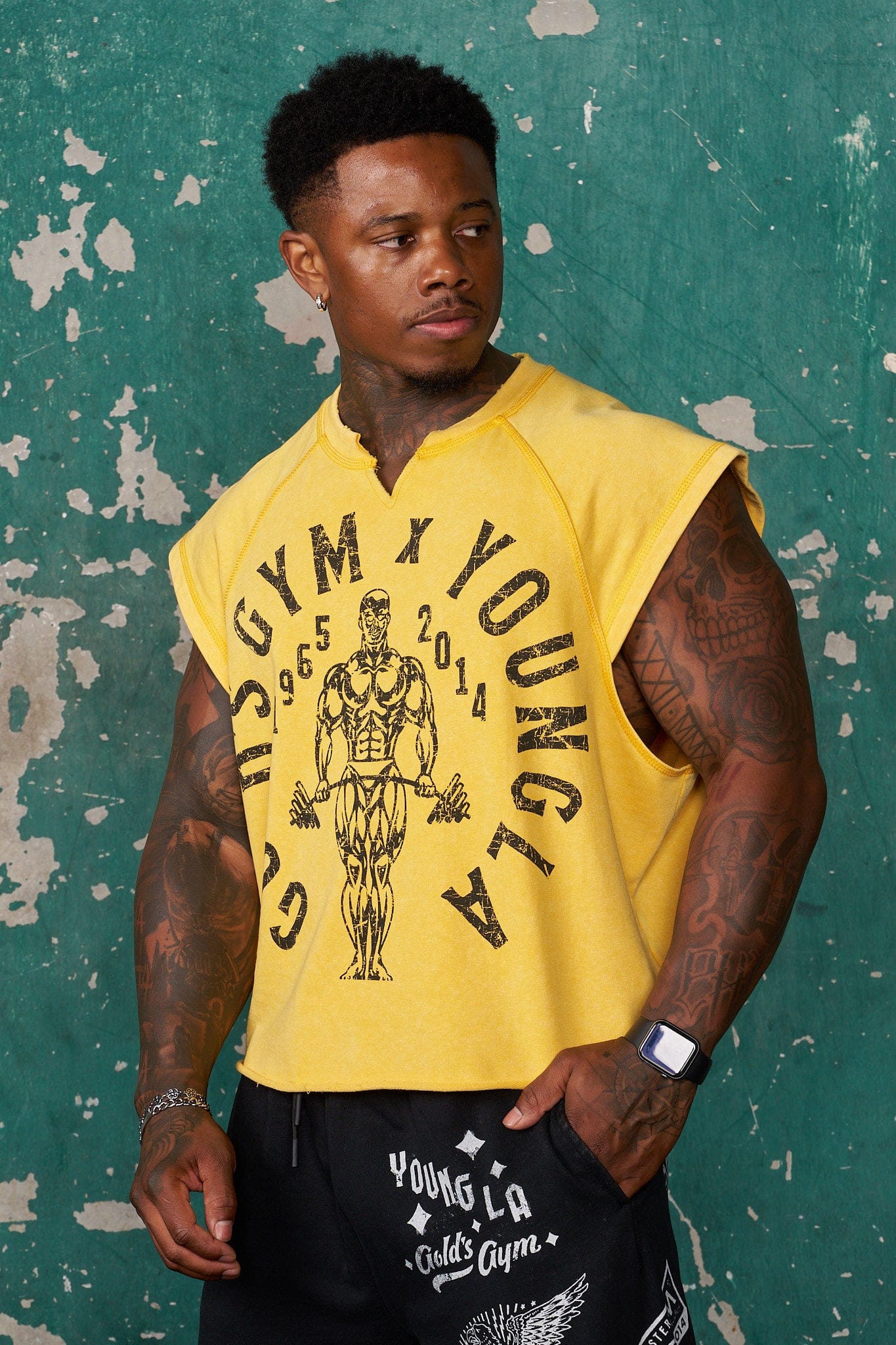 Front view of Golds Gym vintage cut off shirt in gym setting.
