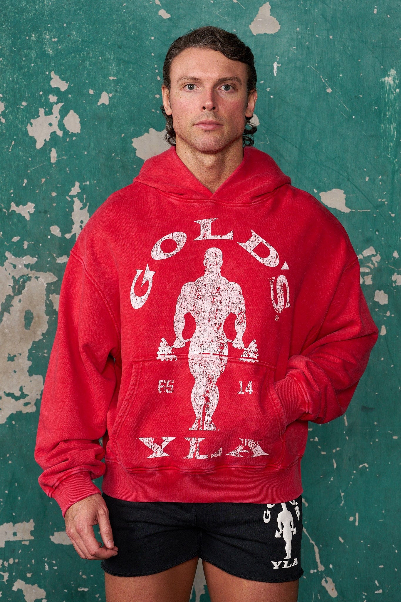 Front view of oversized black pullover showing Gold's Gym distressed graphic