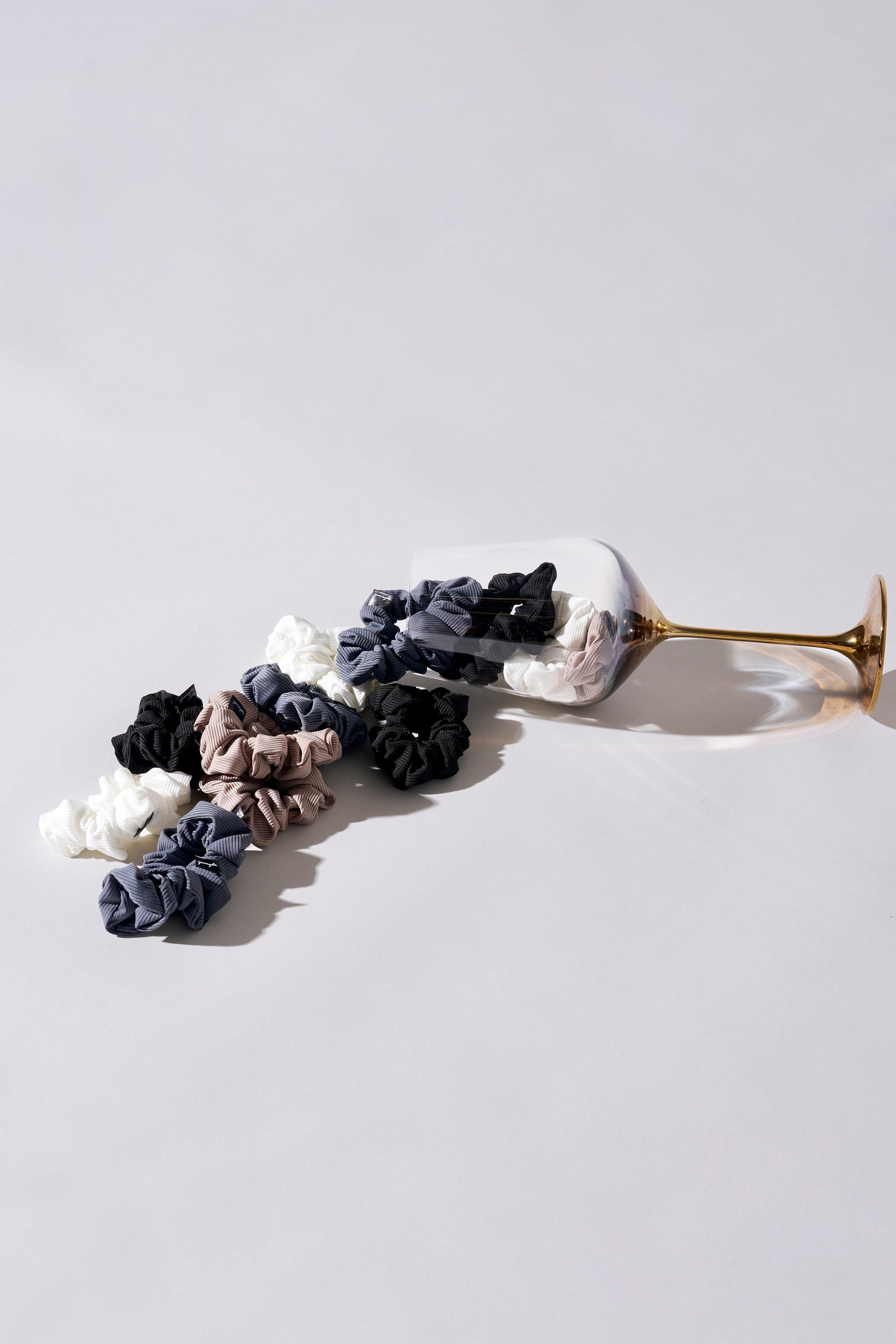 Luxury silk scrunchies displayed in a stylish arrangement, showcasing their soft texture.