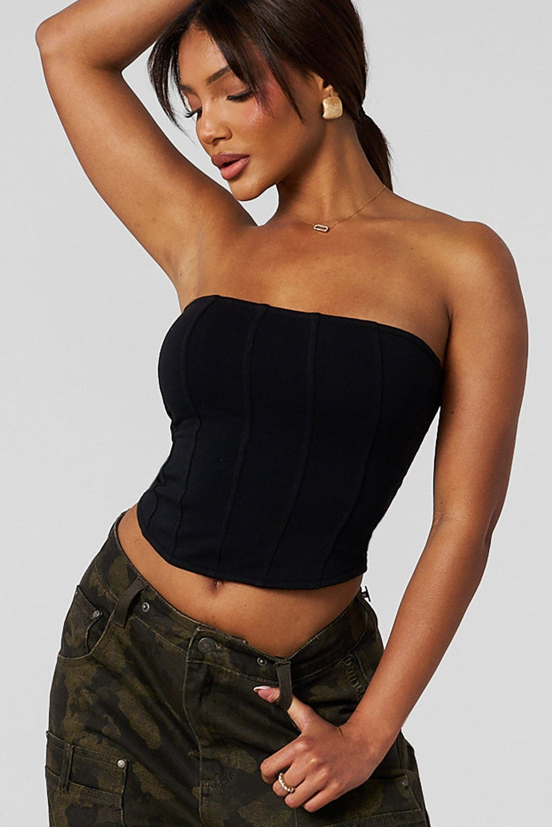 Front-view of black corset on model styled for nightwear.