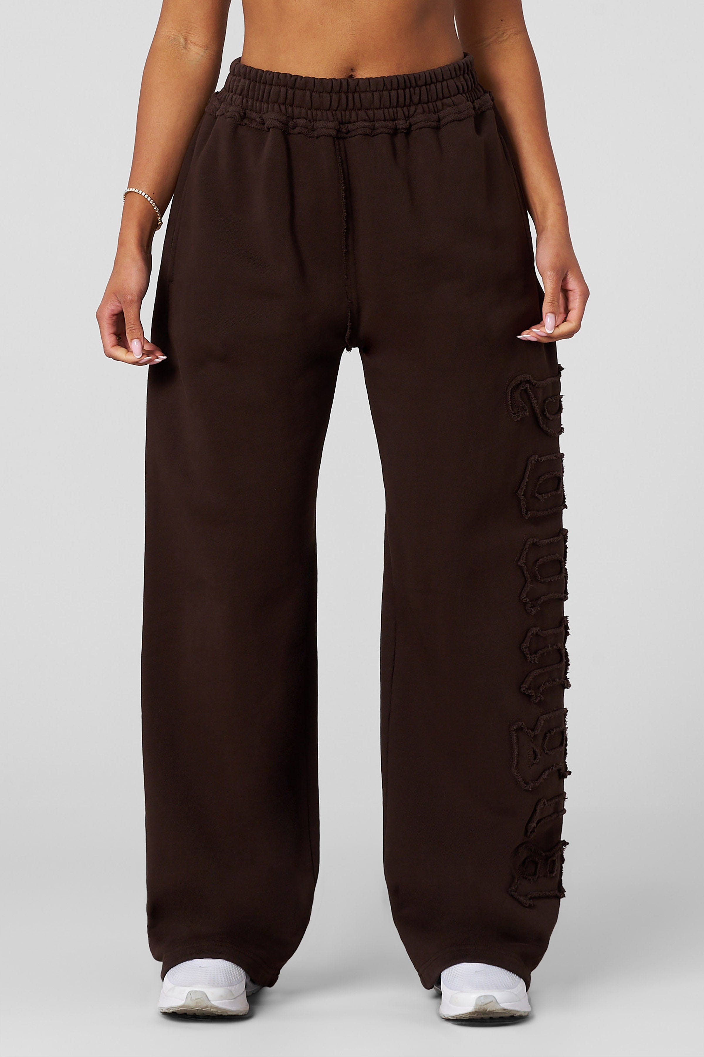 Model lounging in organic cotton joggers, ideal for everyday wear.