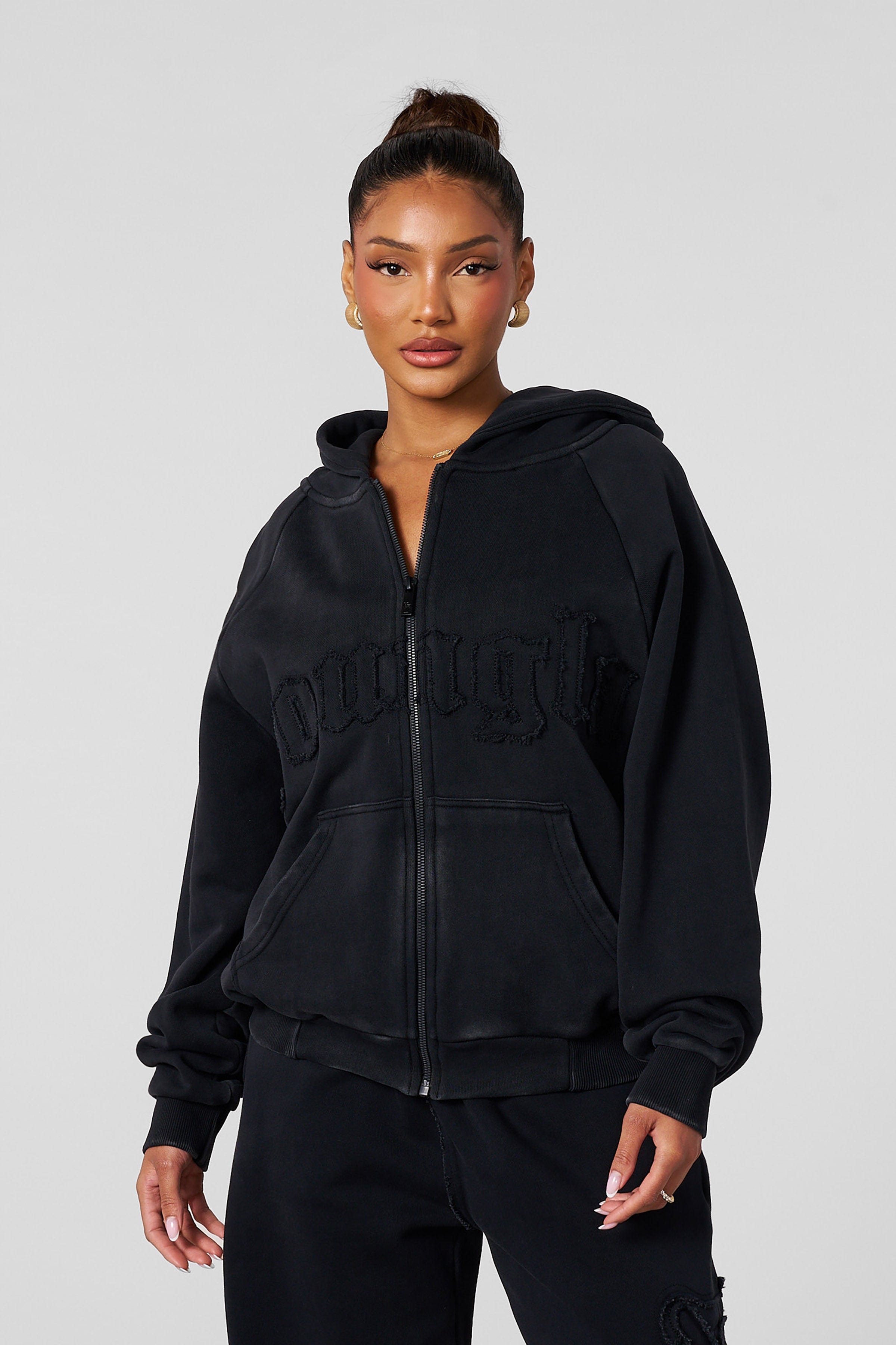 Close-up of the ribbed cuffs and hem of the cotton hoodie.