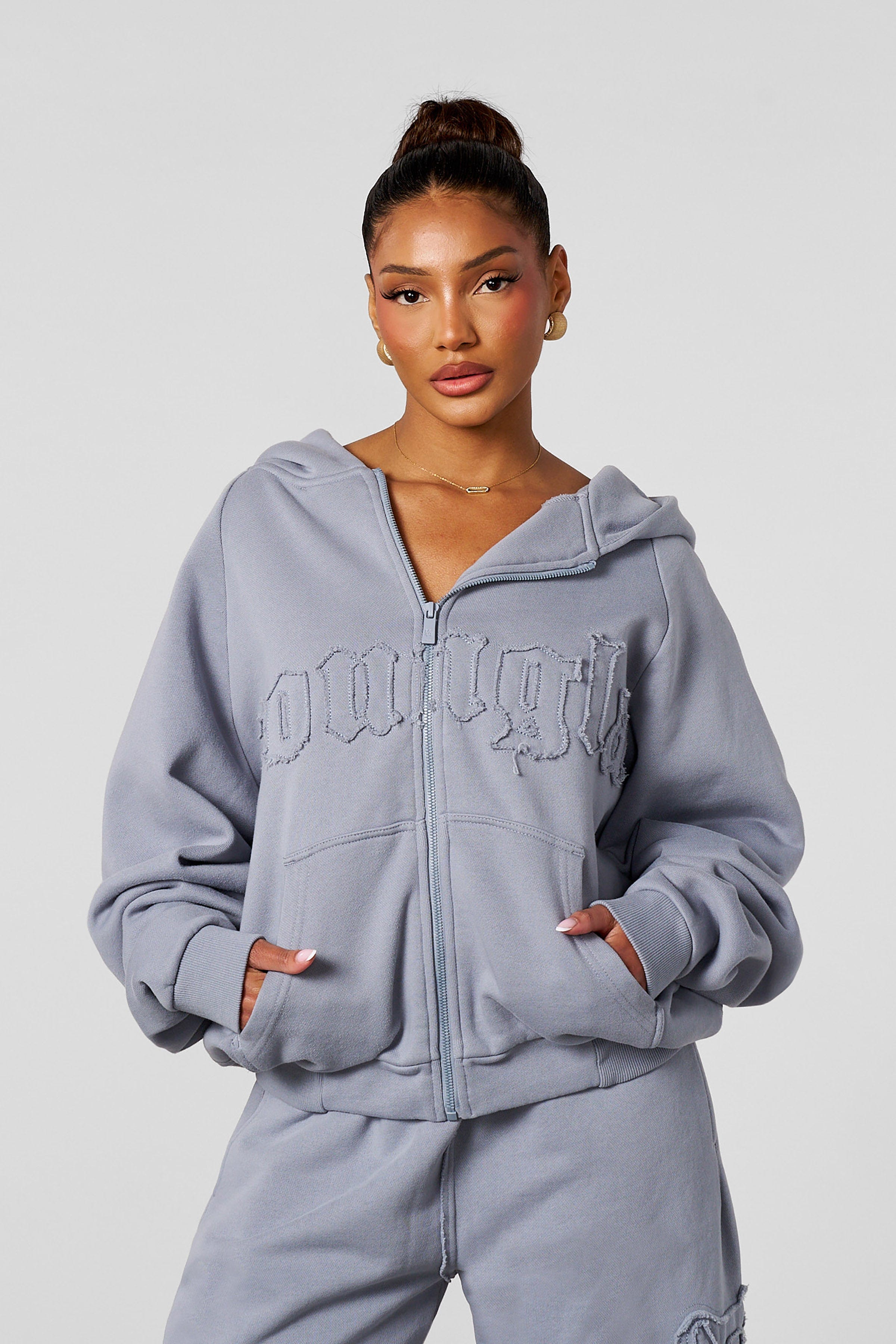Model wearing the black zip-up hoodie, ideal for casual outings.