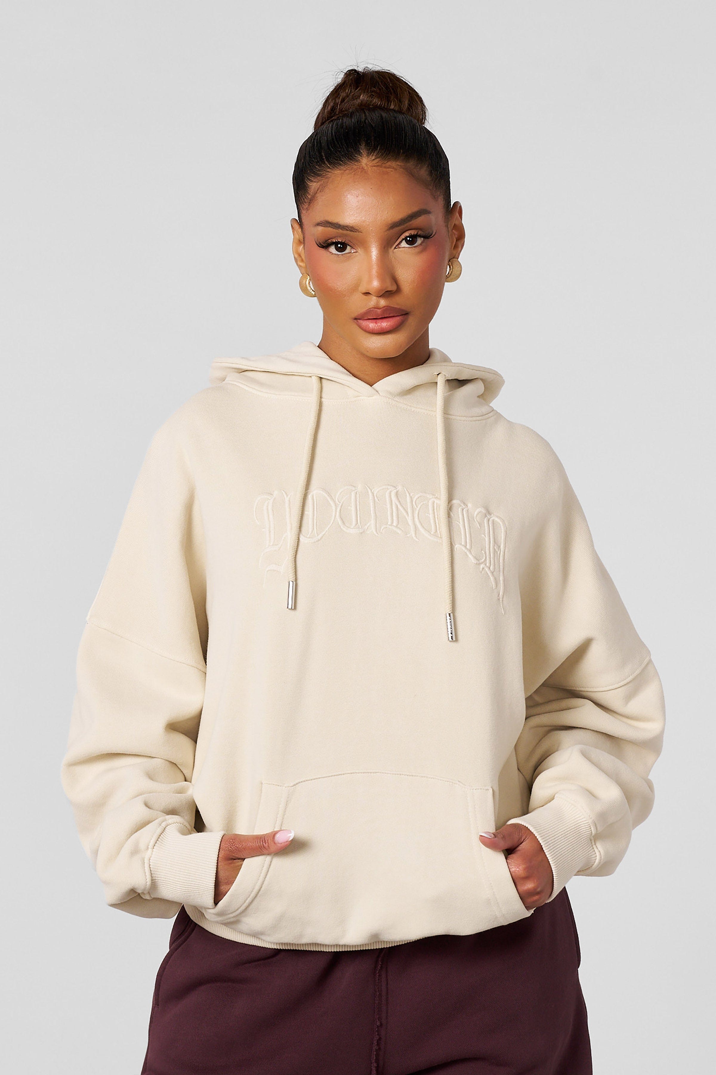 Front view of the embroidered hoodie showcasing detailed embroidery on soft cotton fabric
