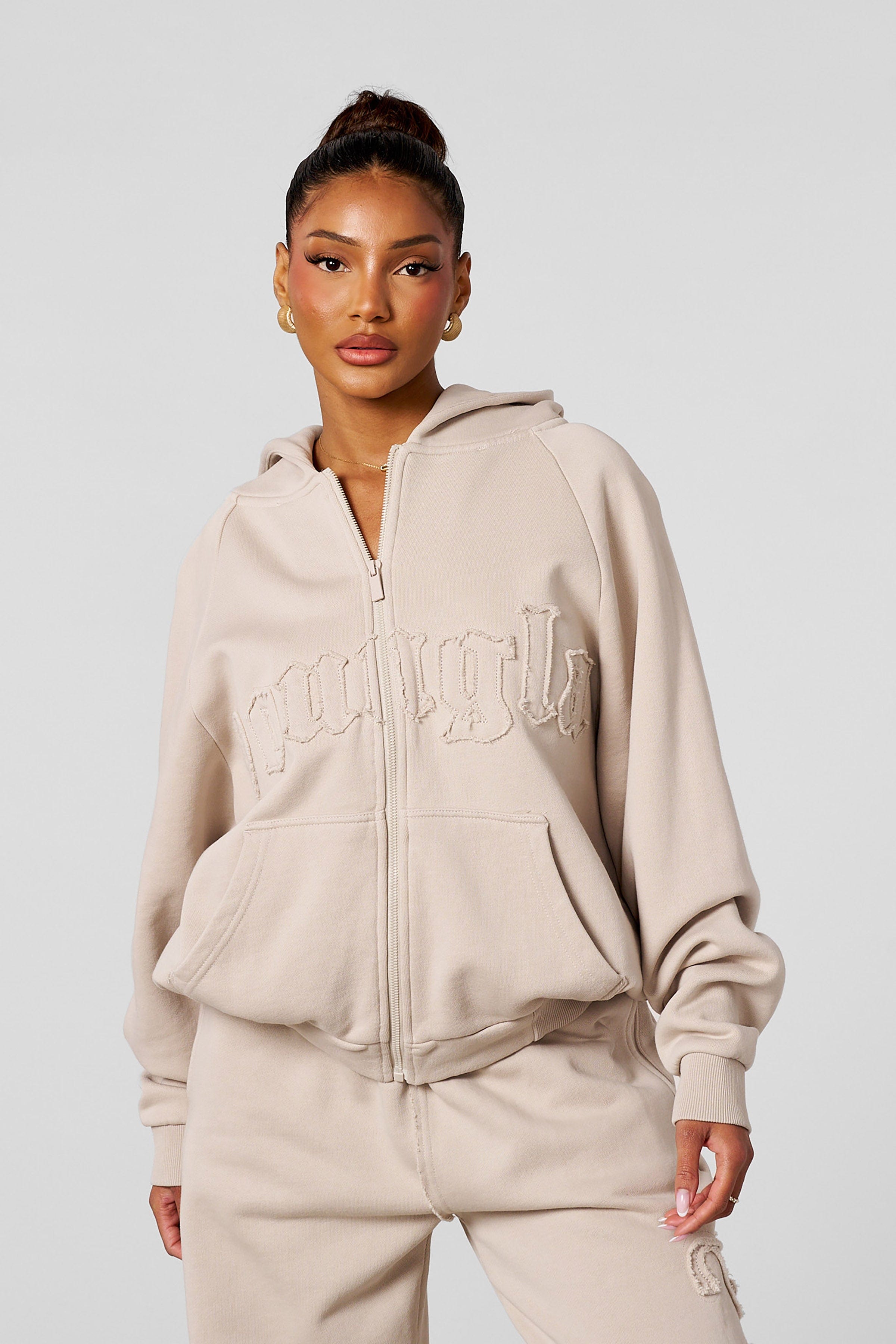 Model wearing the black zip-up hoodie, ideal for casual outings.