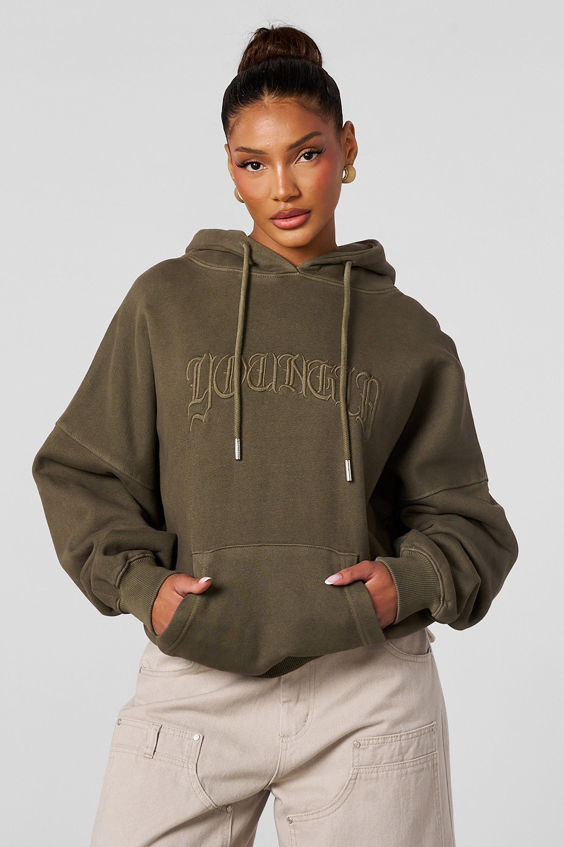 Model wearing the oversized hoodie with embroidered design during casual outing