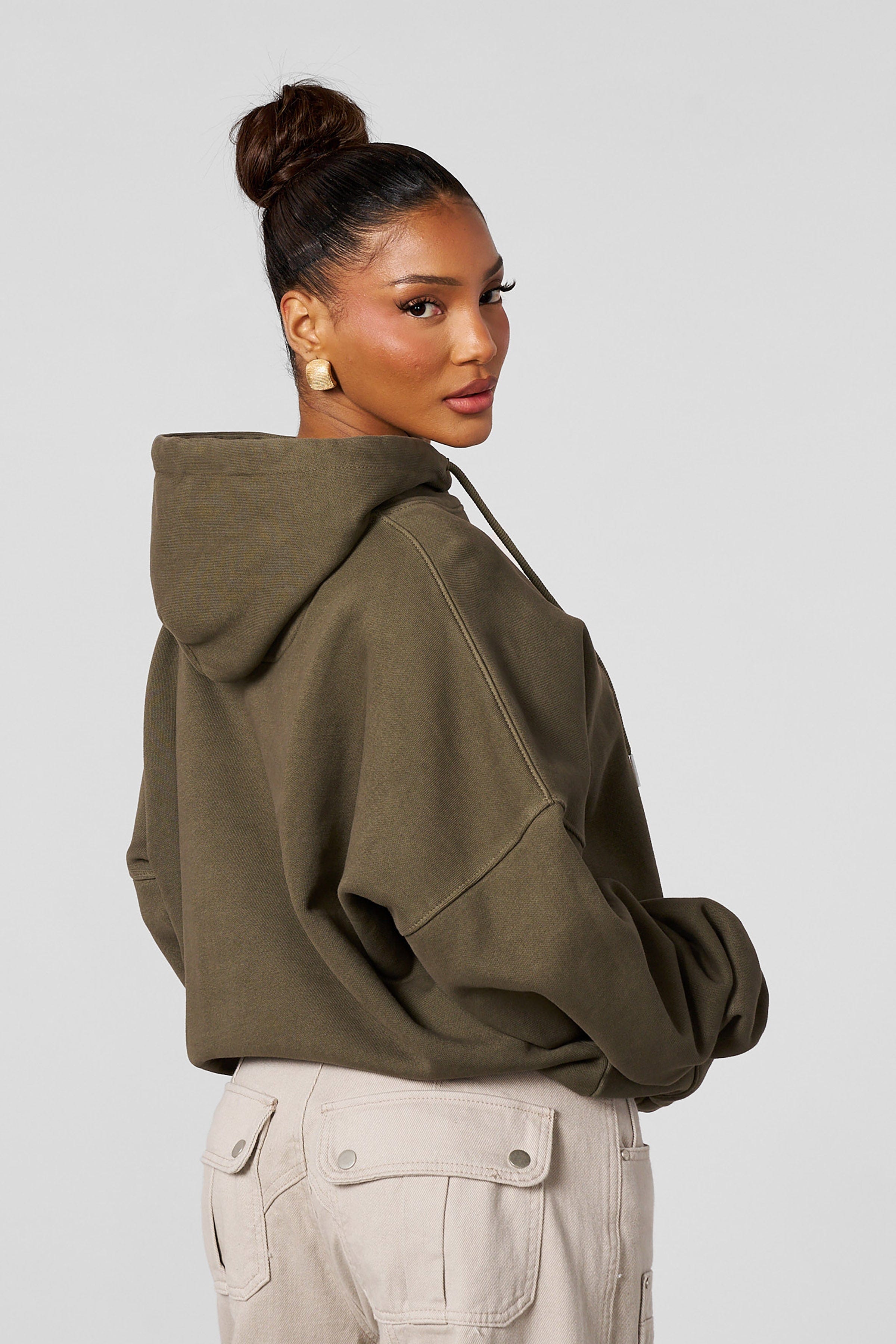Model wearing the oversized hoodie with embroidered design during casual outing