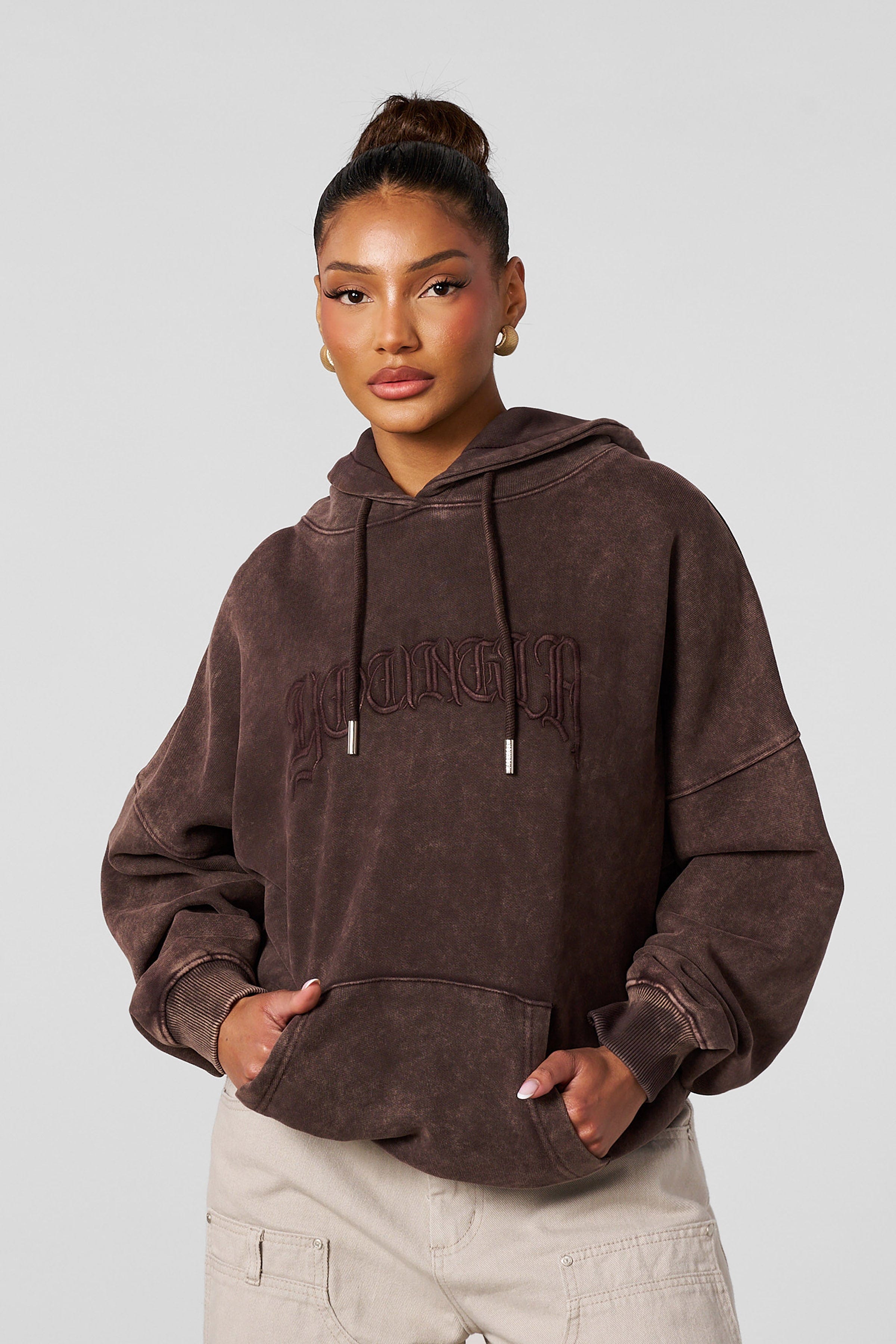 Model wearing the oversized hoodie with embroidered design during casual outing