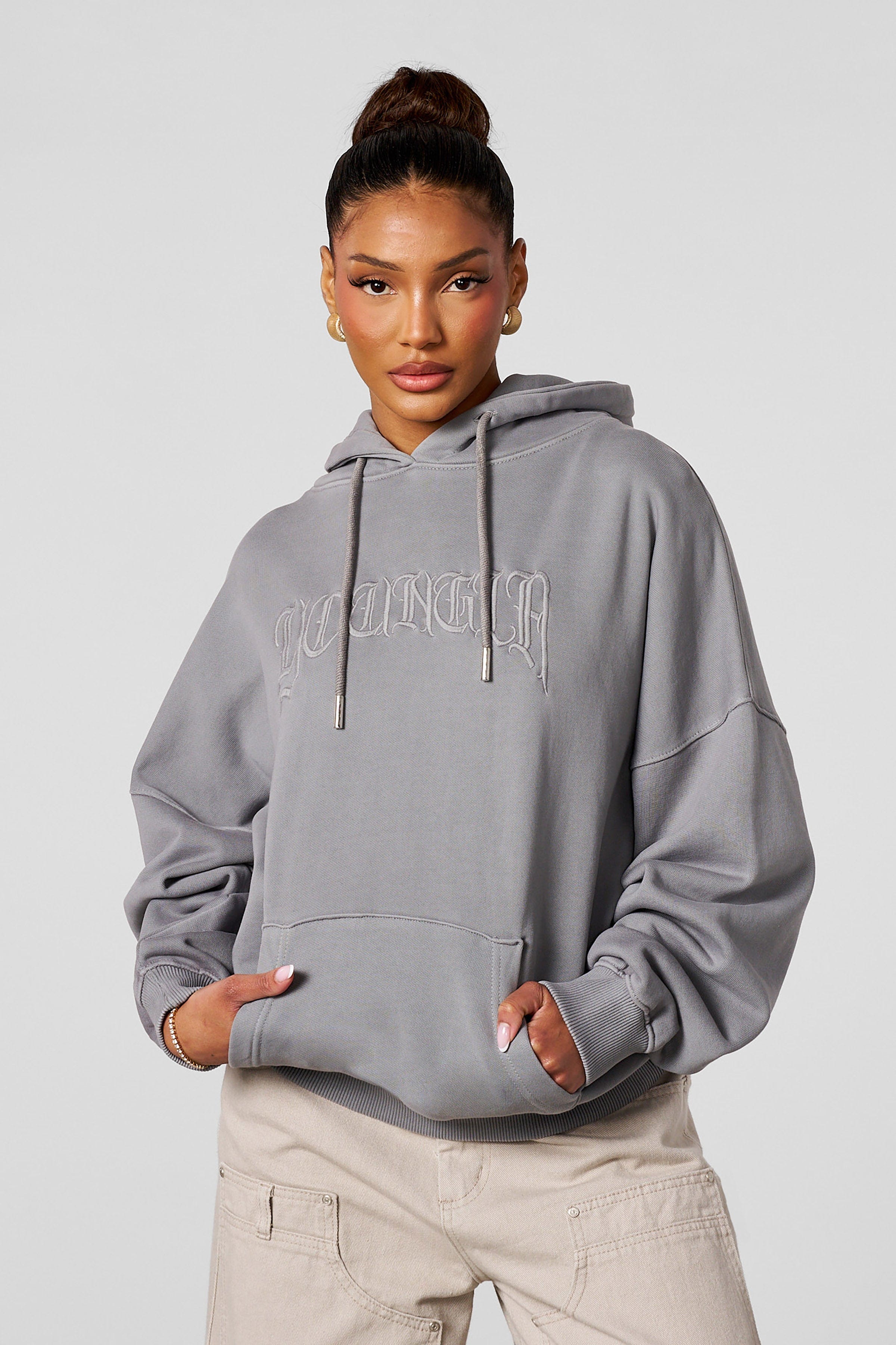 Model wearing the oversized hoodie with embroidered design during casual outing
