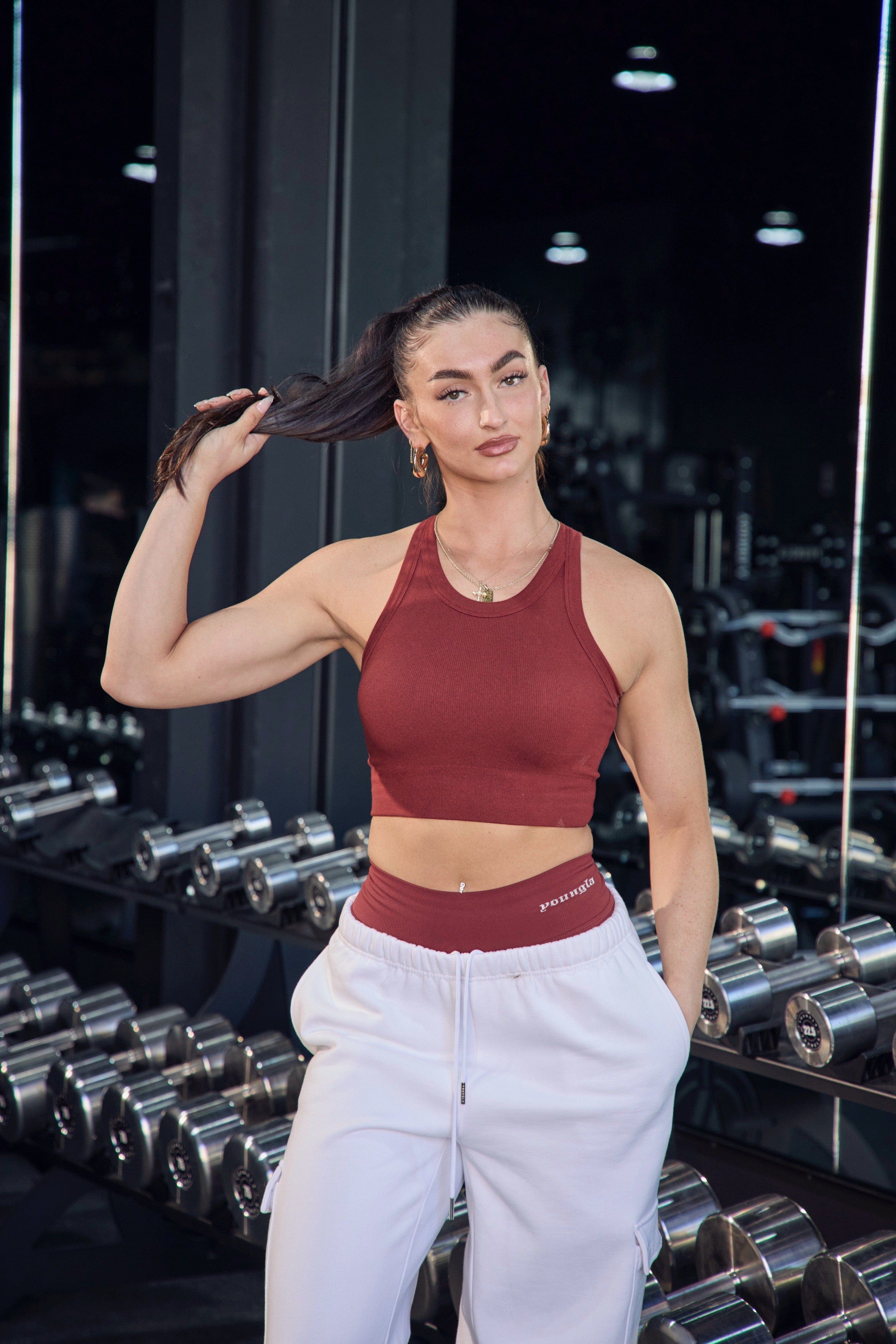 Model wearing the high neck sports bra paired with matching Lift Leggings outdoors.