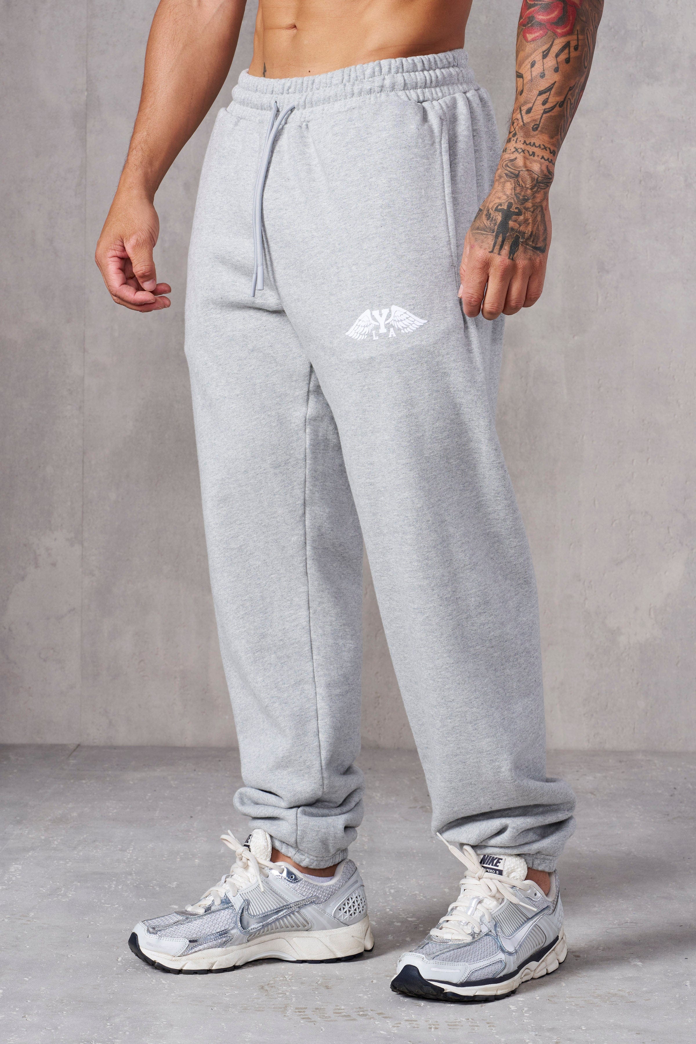 Front and back view of mens sweats in a neutral tone.