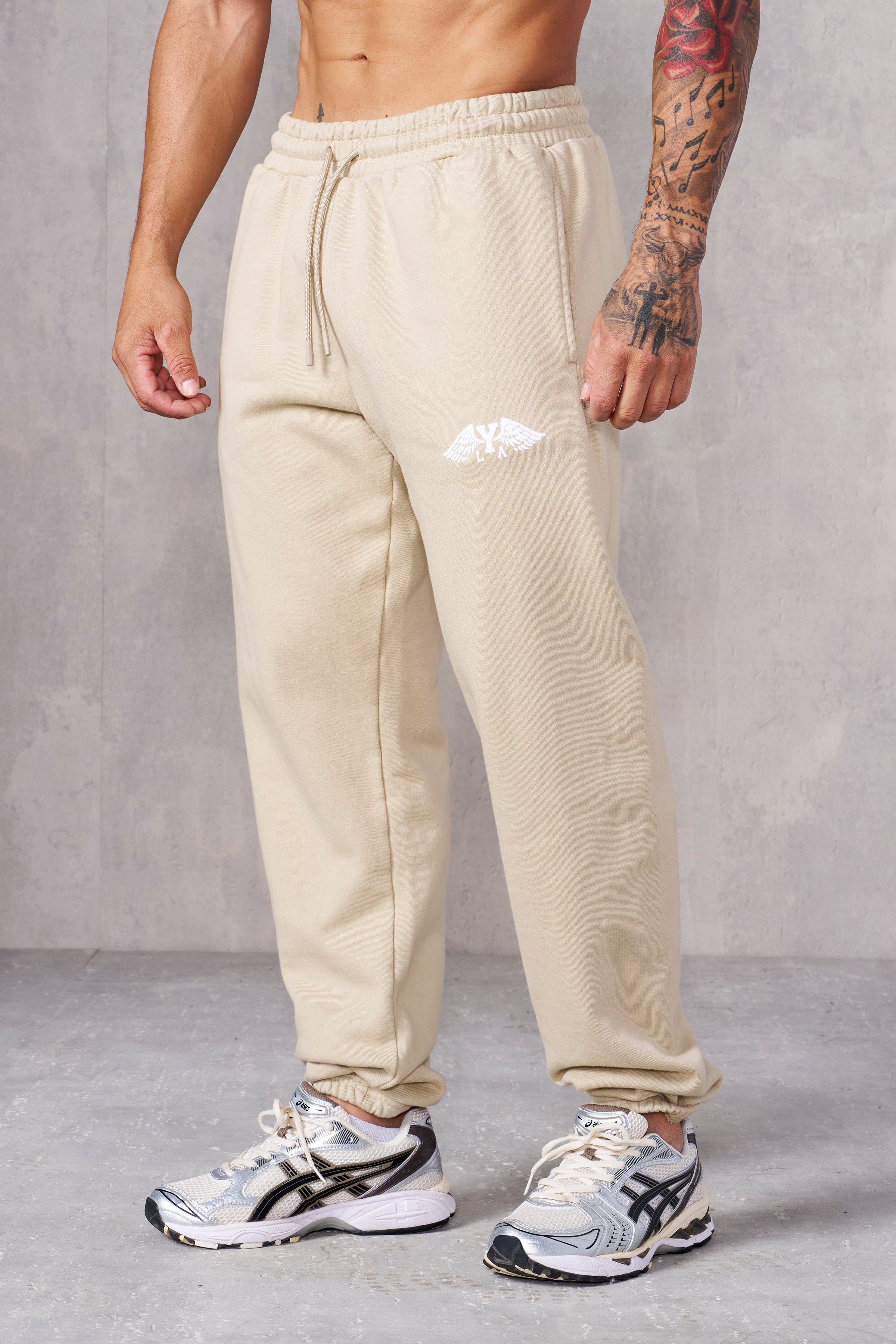 Lifestyle shot of cotton joggers ladies version styled with sneakers.