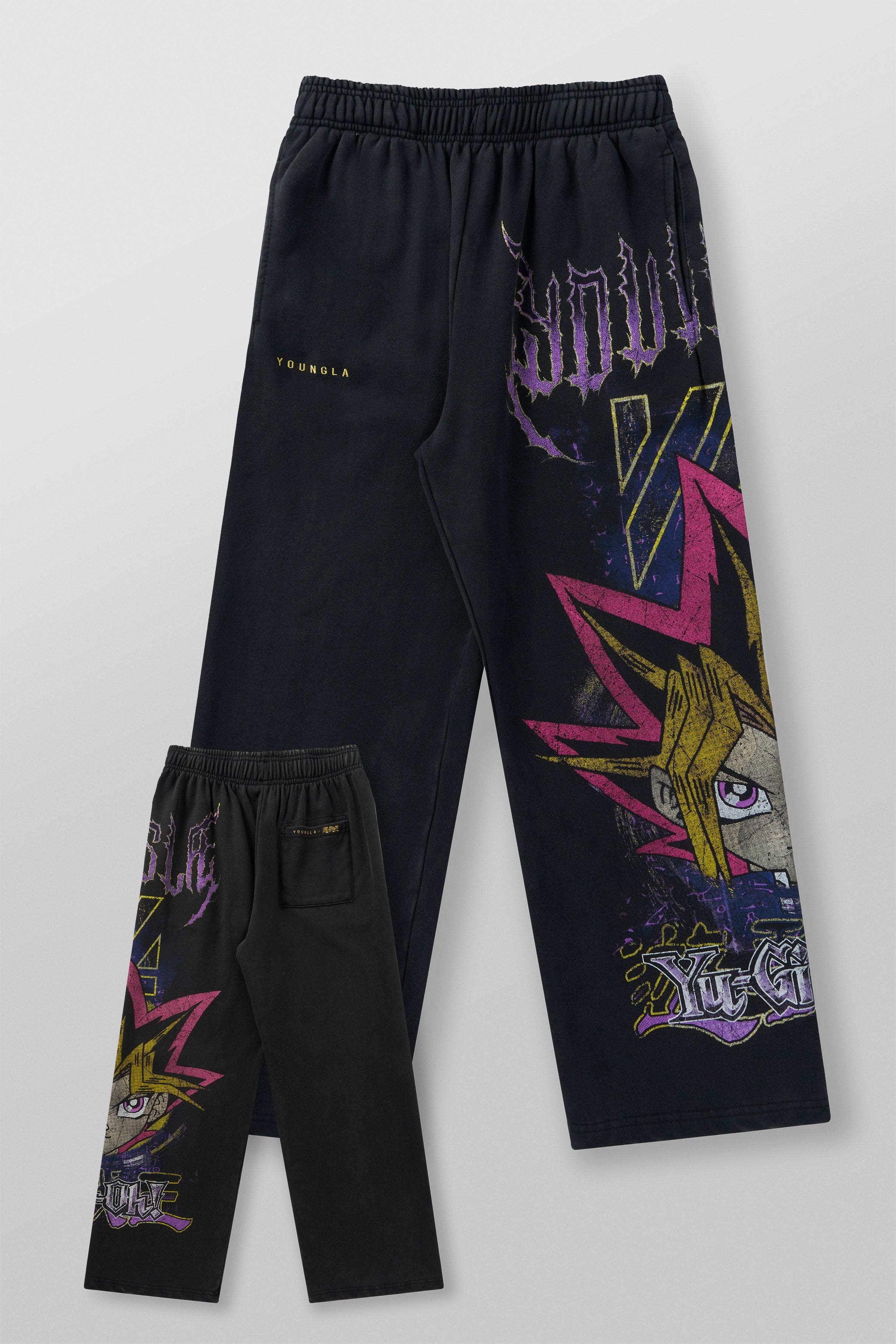 Model wearing baggy sweatpants with graphic design during relaxed outdoor activity