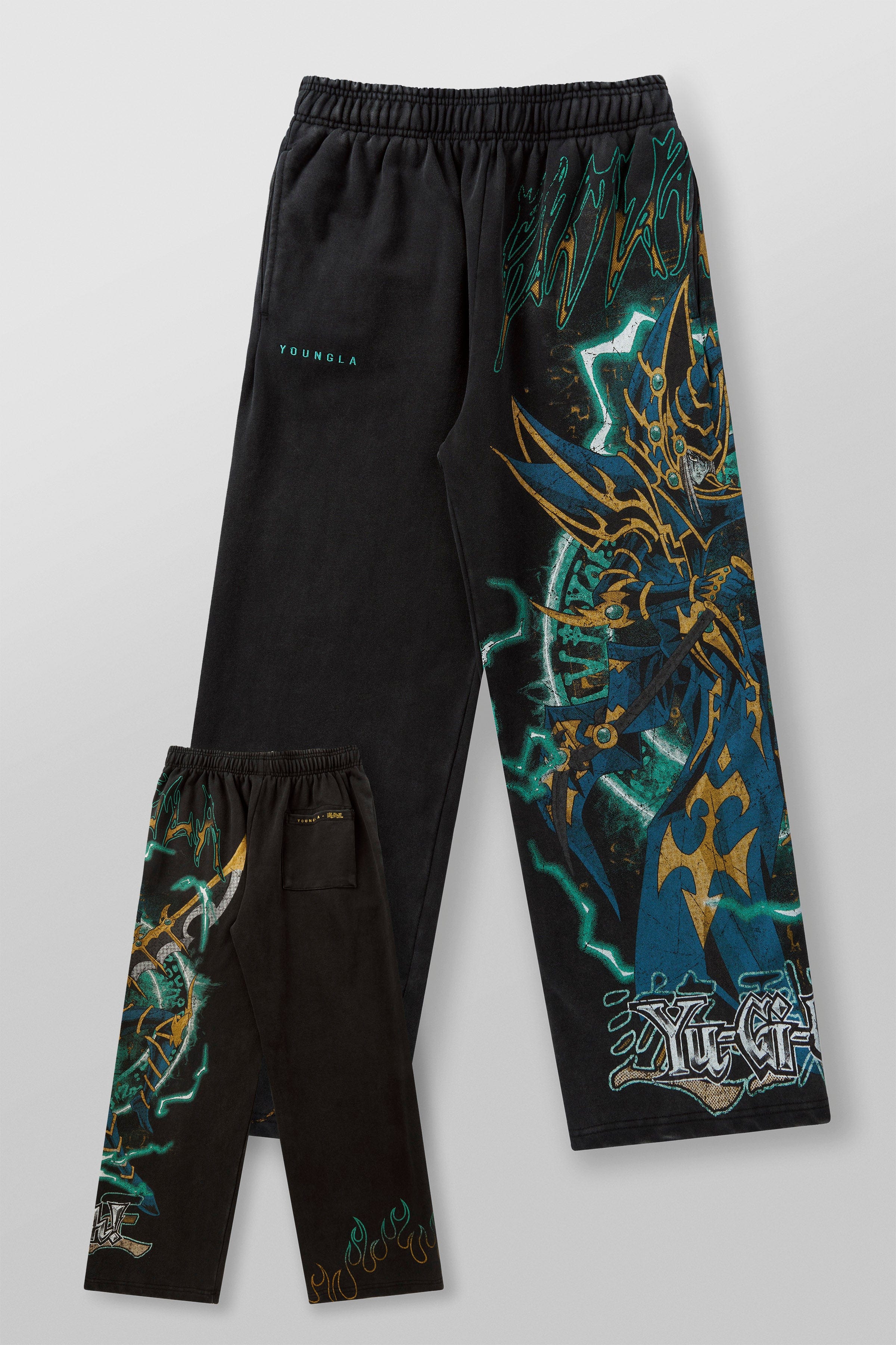 Model wearing baggy sweatpants with graphic design during relaxed outdoor activity