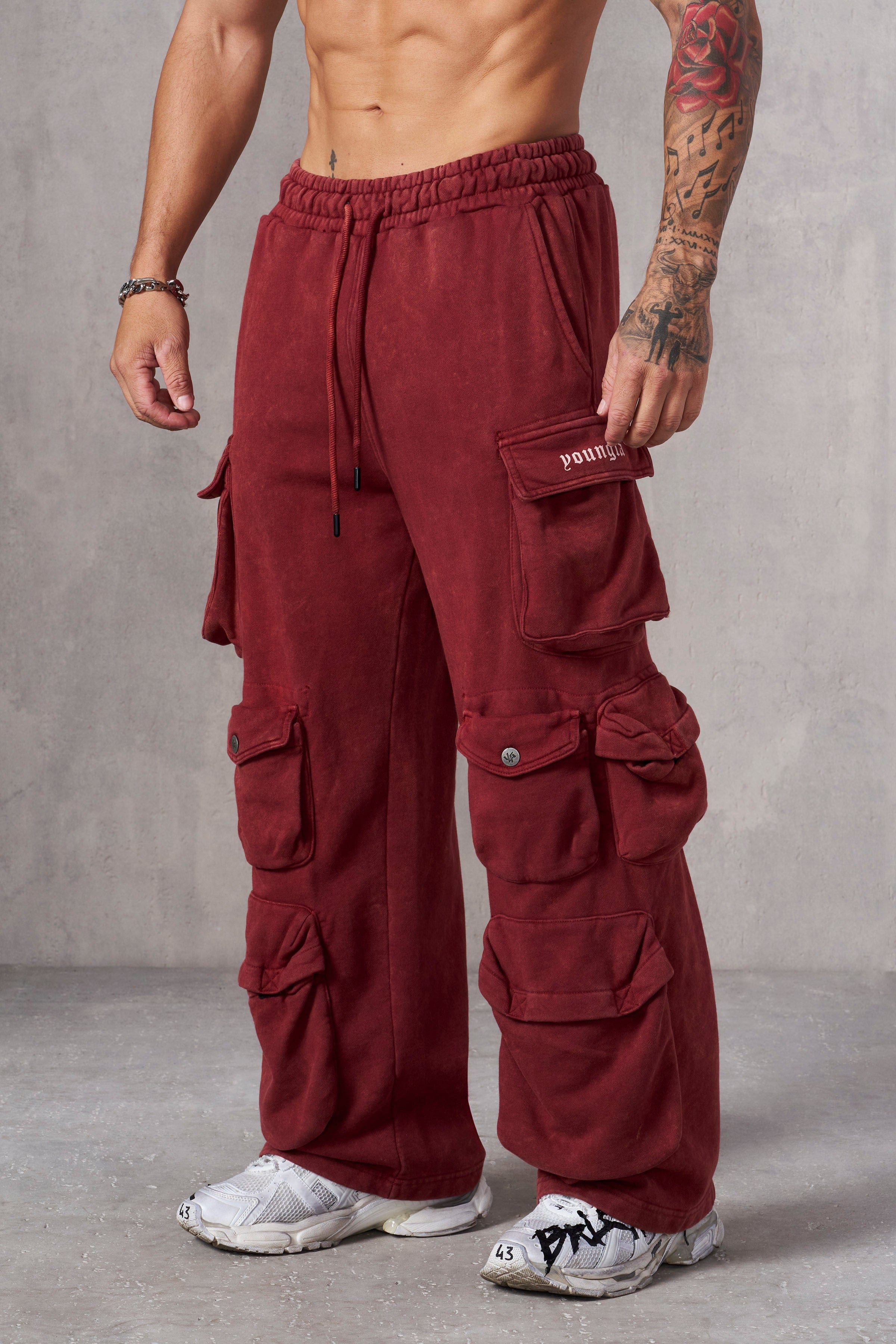 Cargo pocket close-up on mens joggers featuring YLA branding