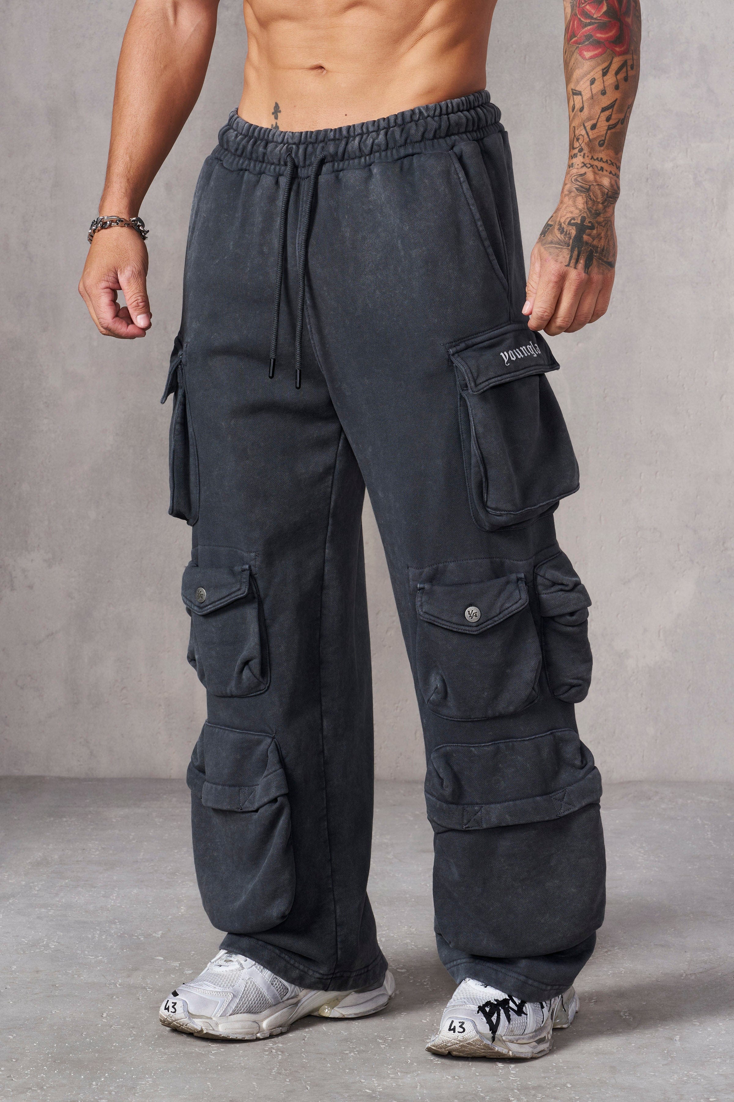Side angle showing acid-wash detail and baggy fit on black joggers