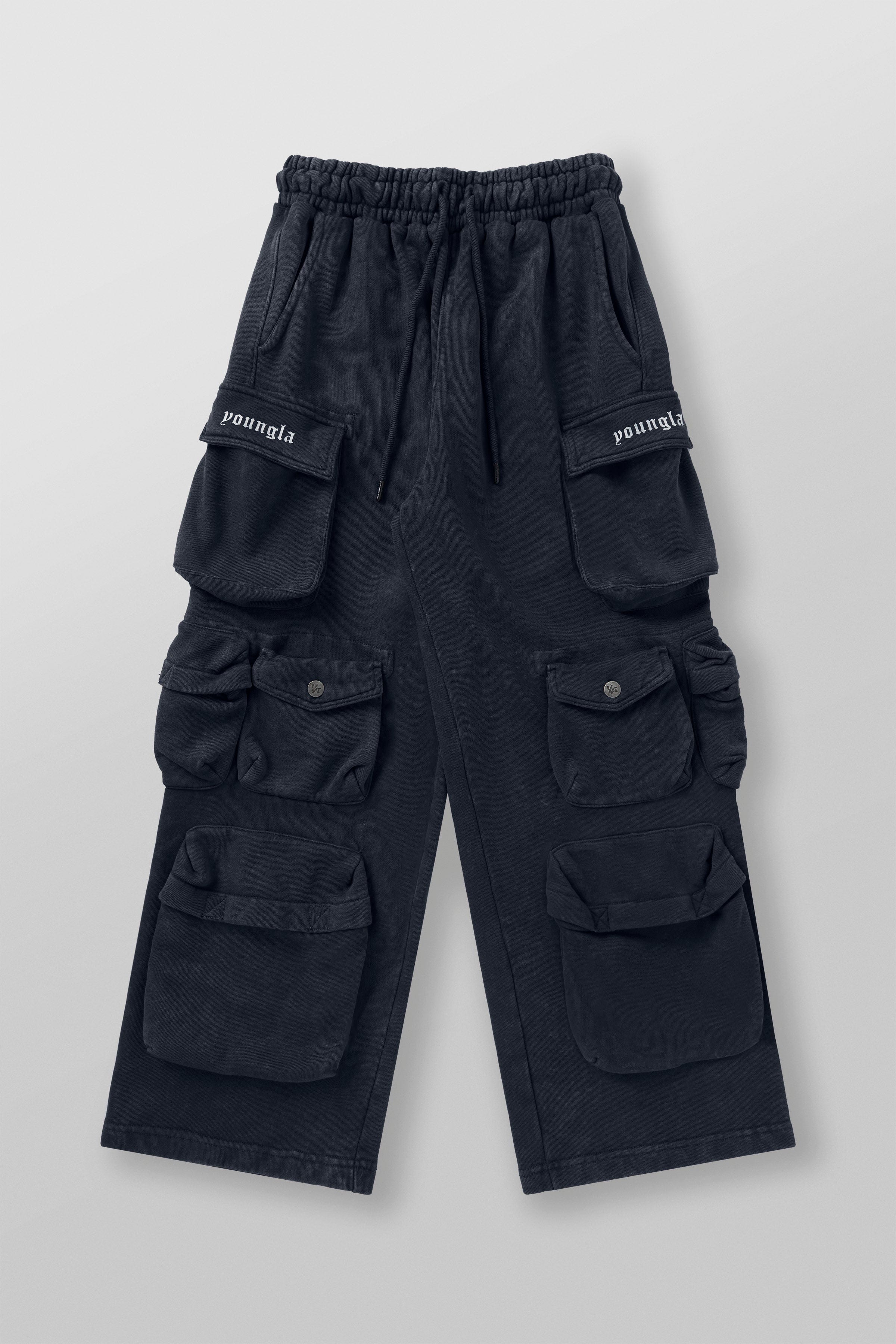 Side angle showing acid-wash detail and baggy fit on black joggers