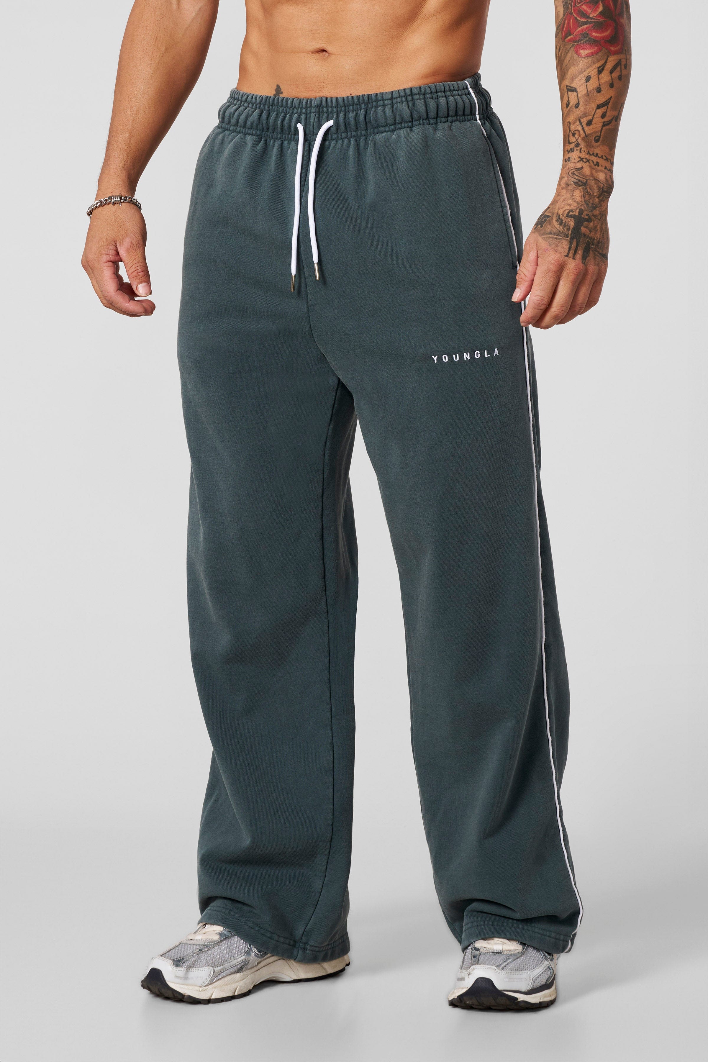 Front view of heavyweight cotton joggers with baggy fit and side piping
