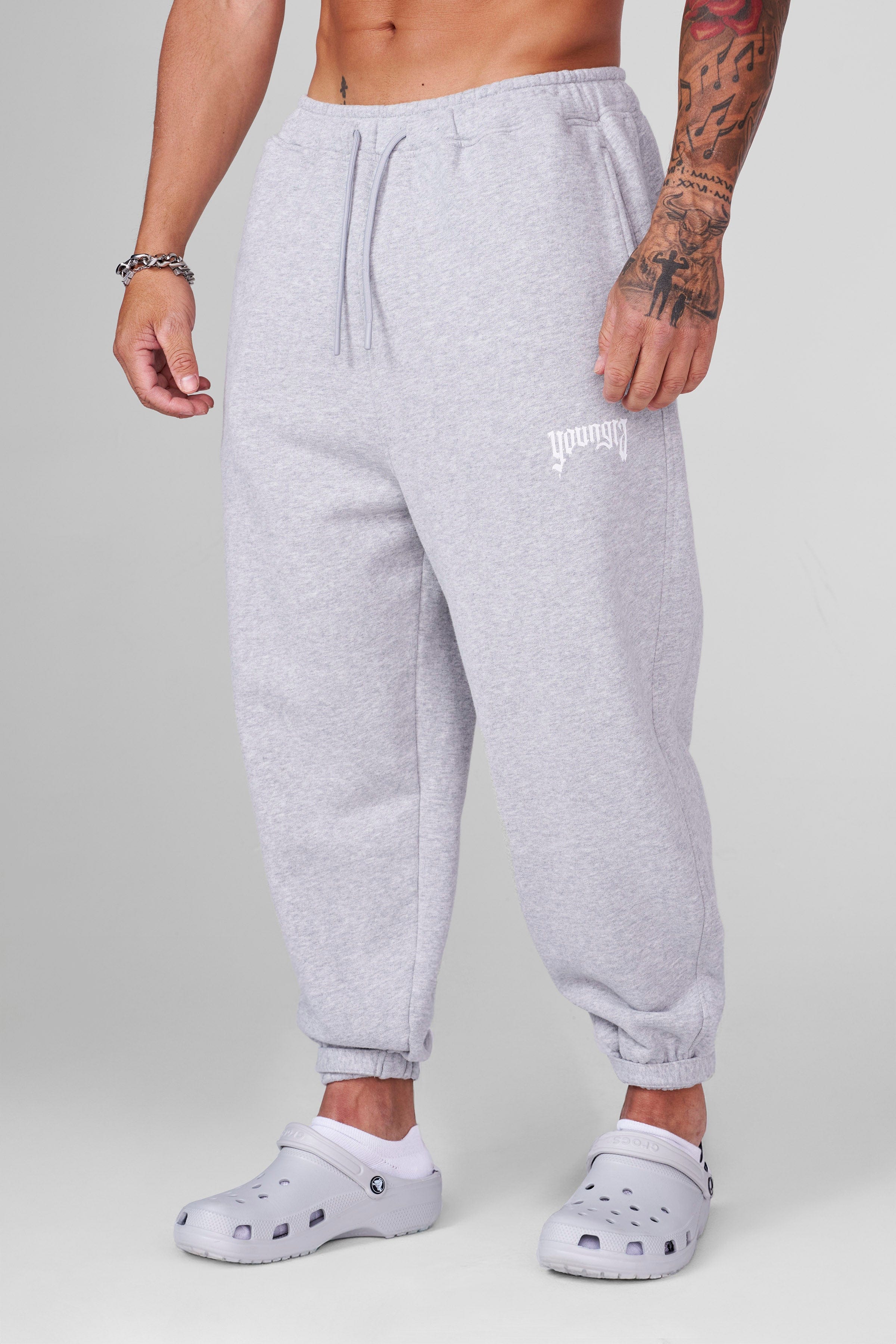 Close-up of velcro strap adjustments on anime joggers for customizable fit.