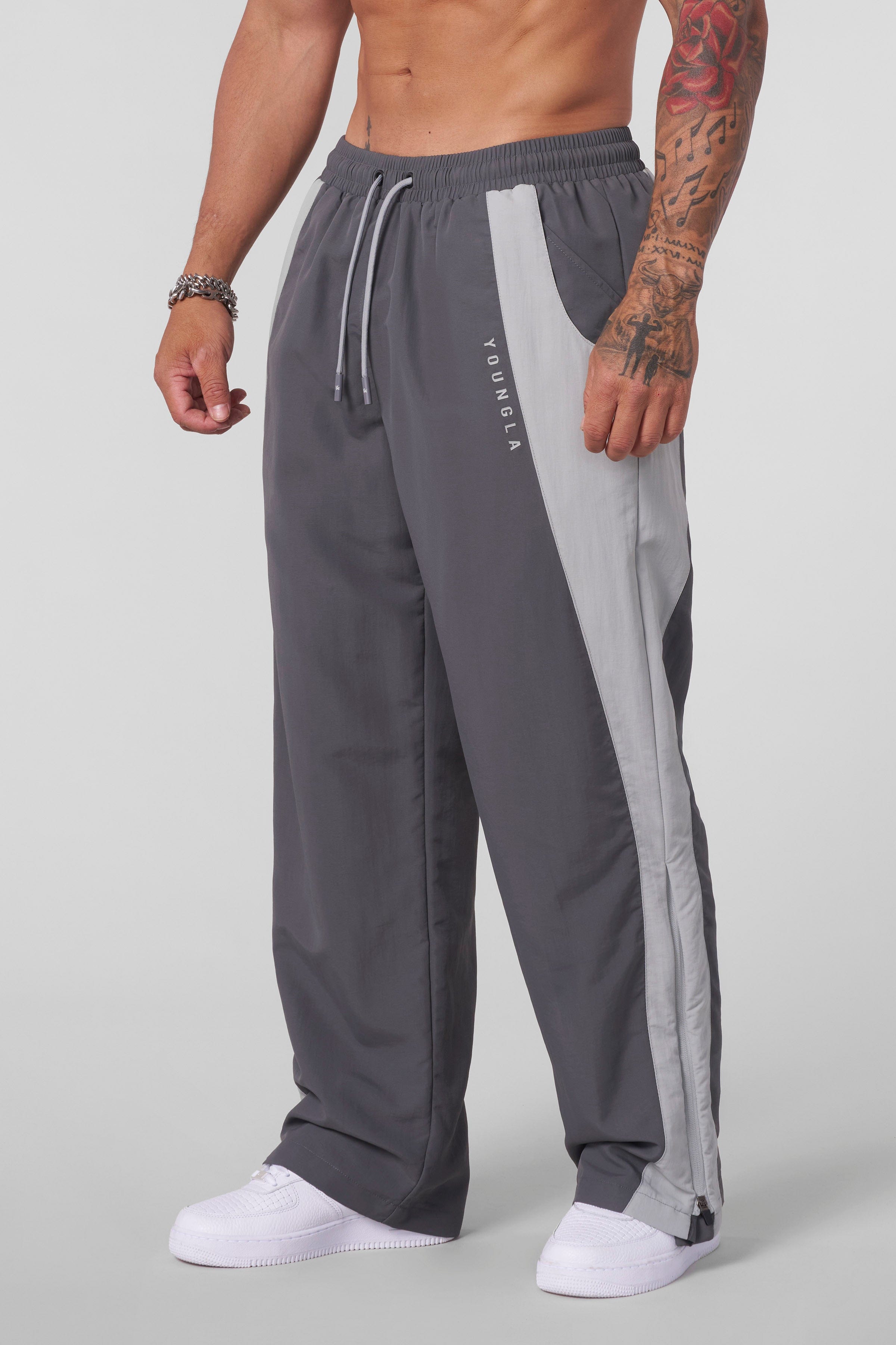 Close-up of zippered leg openings on track pants