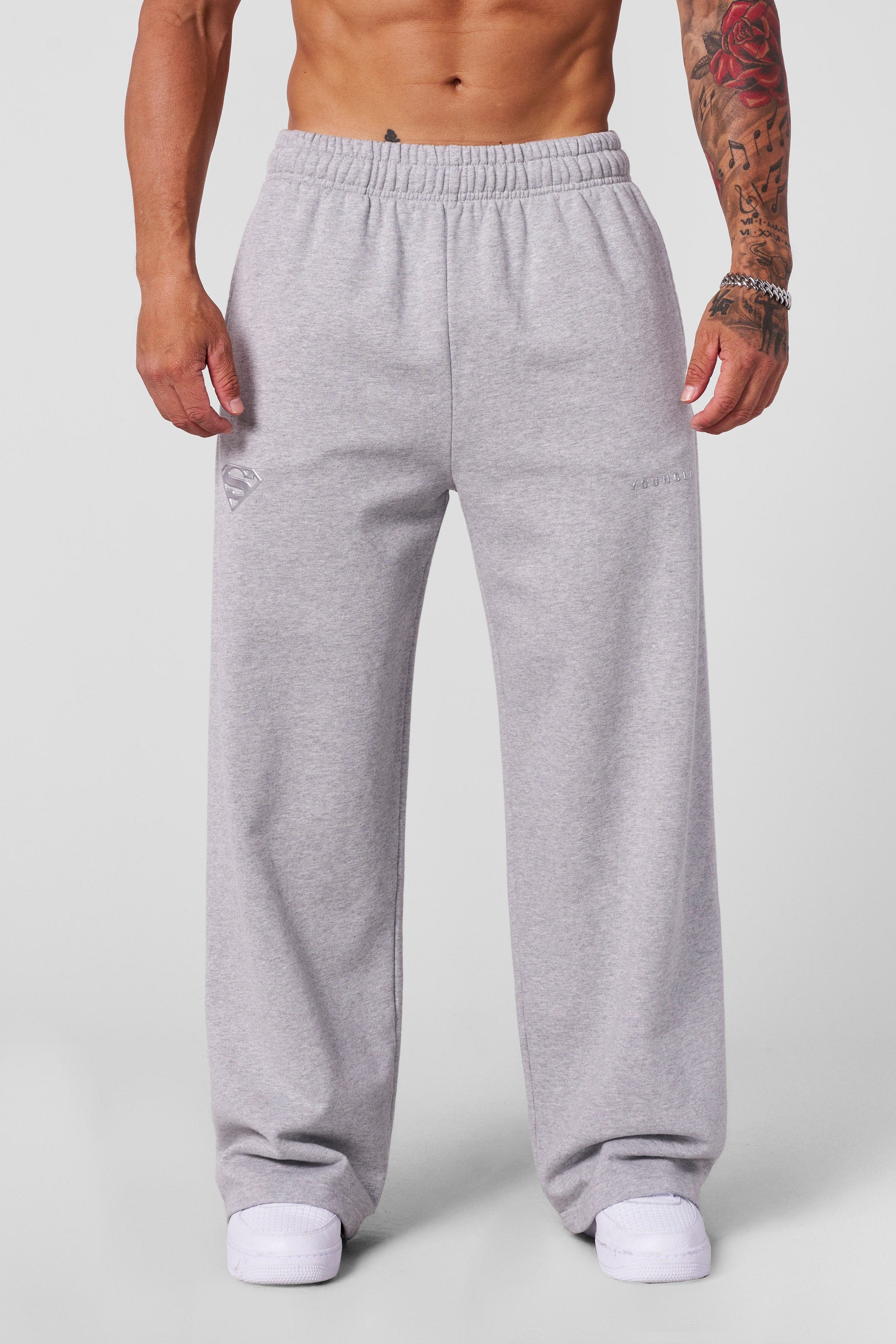 Model wearing Superman sweats in a casual streetwear outfit