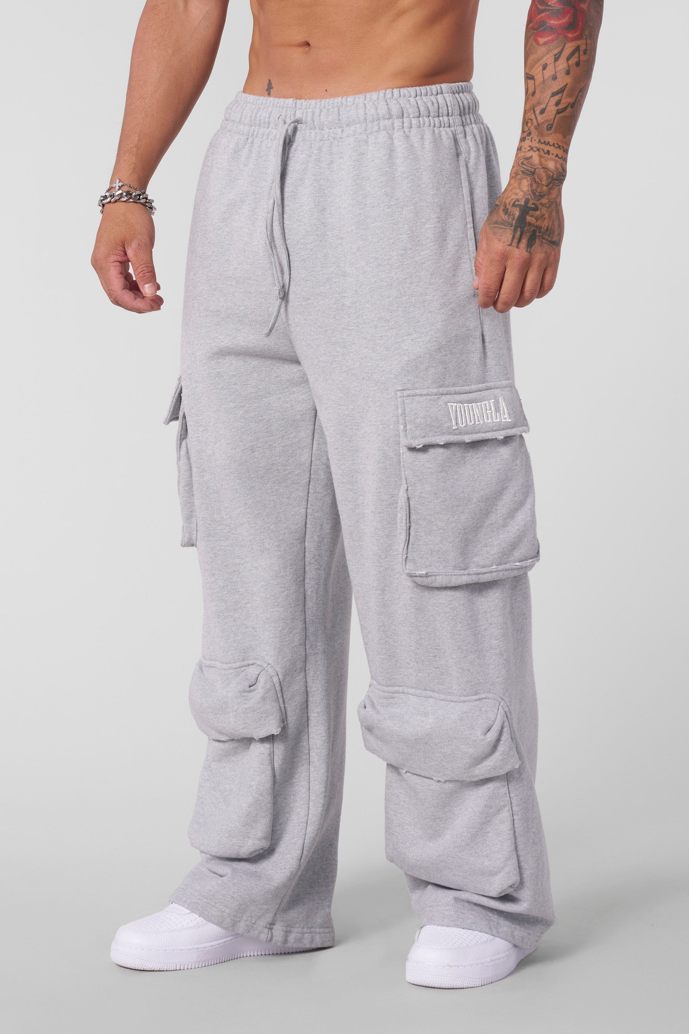 Model wearing Heritage Cargo Sweatpants in a casual streetwear setting.