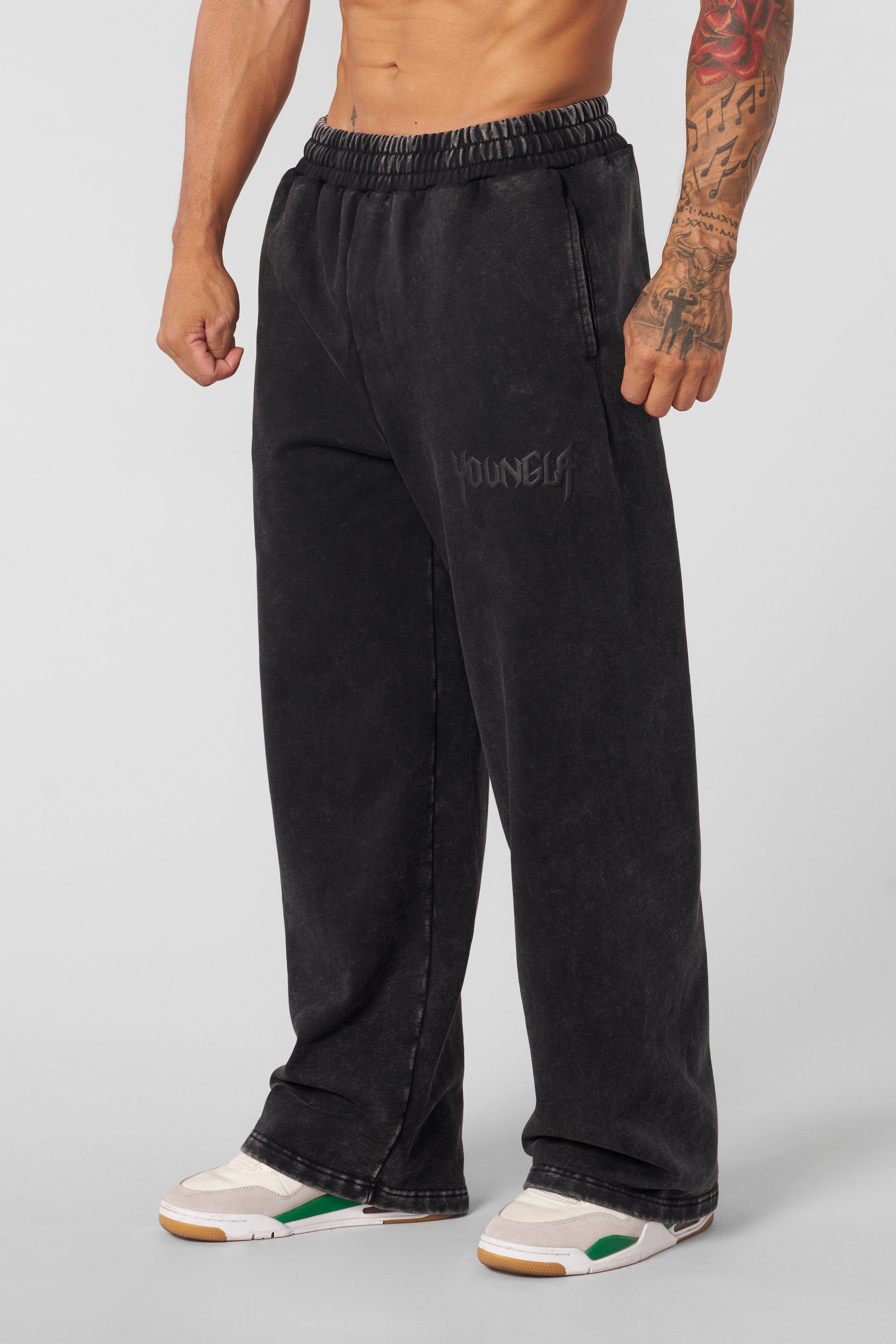 Model wearing baggy black joggers from the Midnight Collection paired with casual sneakers