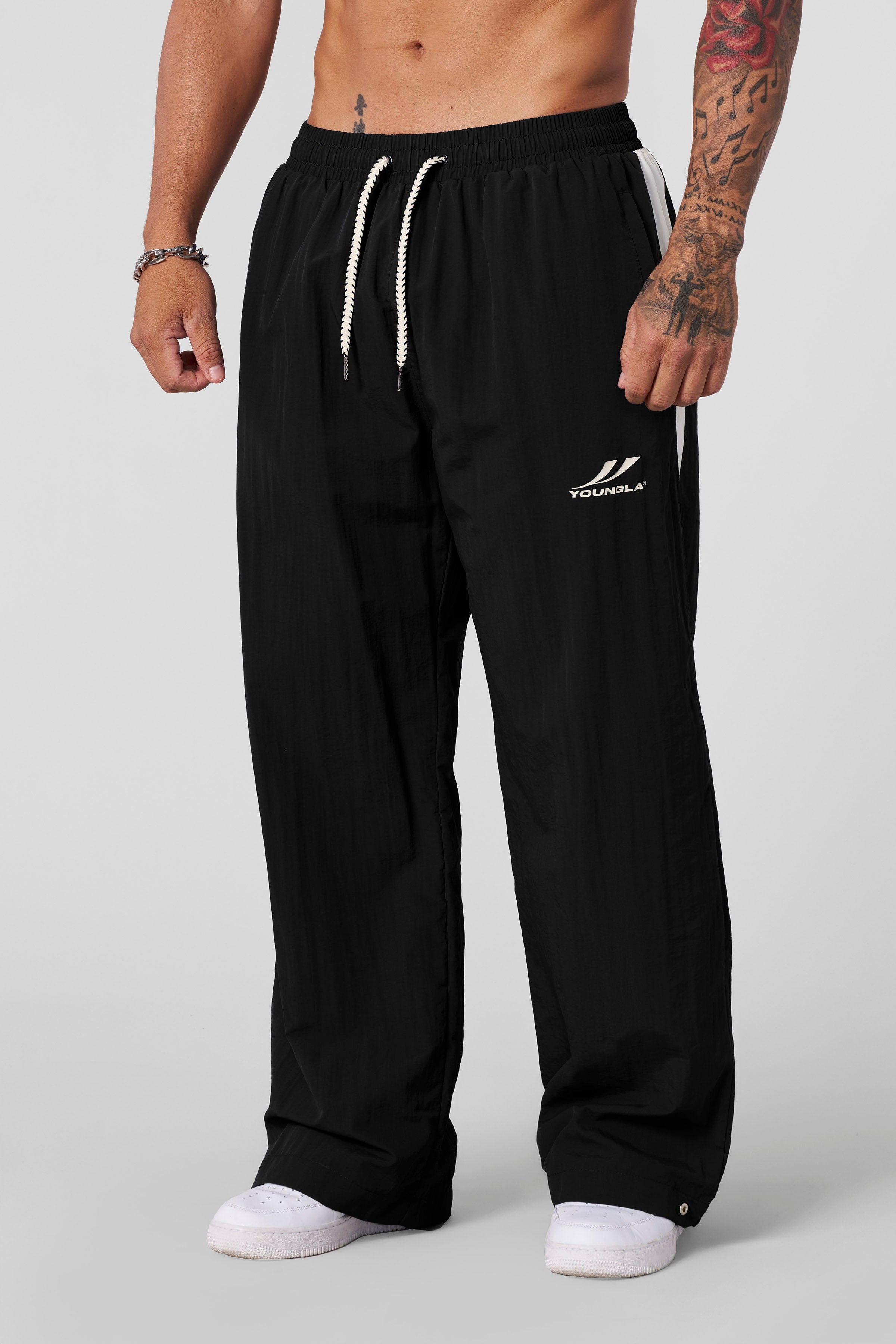 Close-up of snap-button detail on lightweight baggy snow pants.