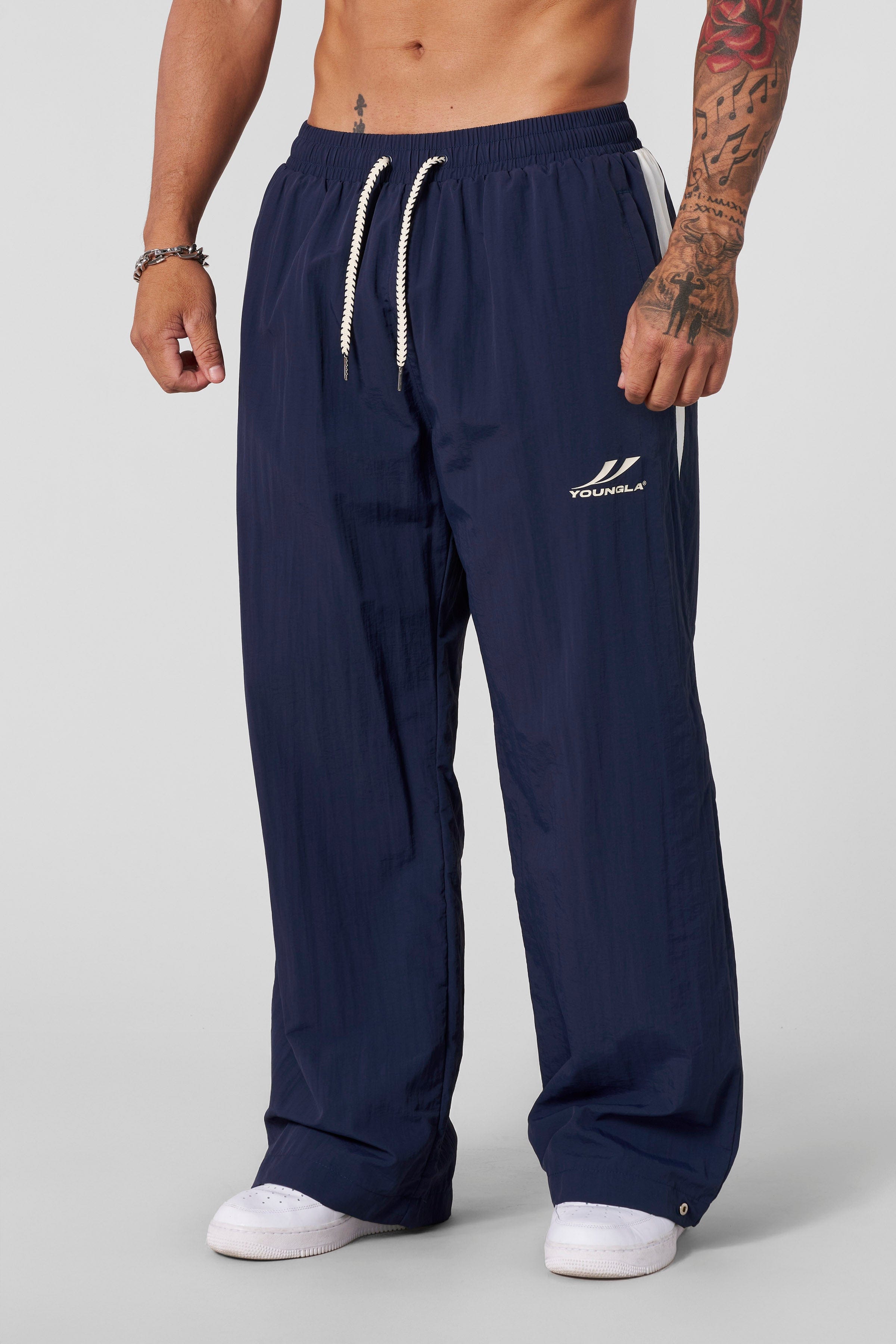 Close-up of snap-button detail on lightweight baggy snow pants.