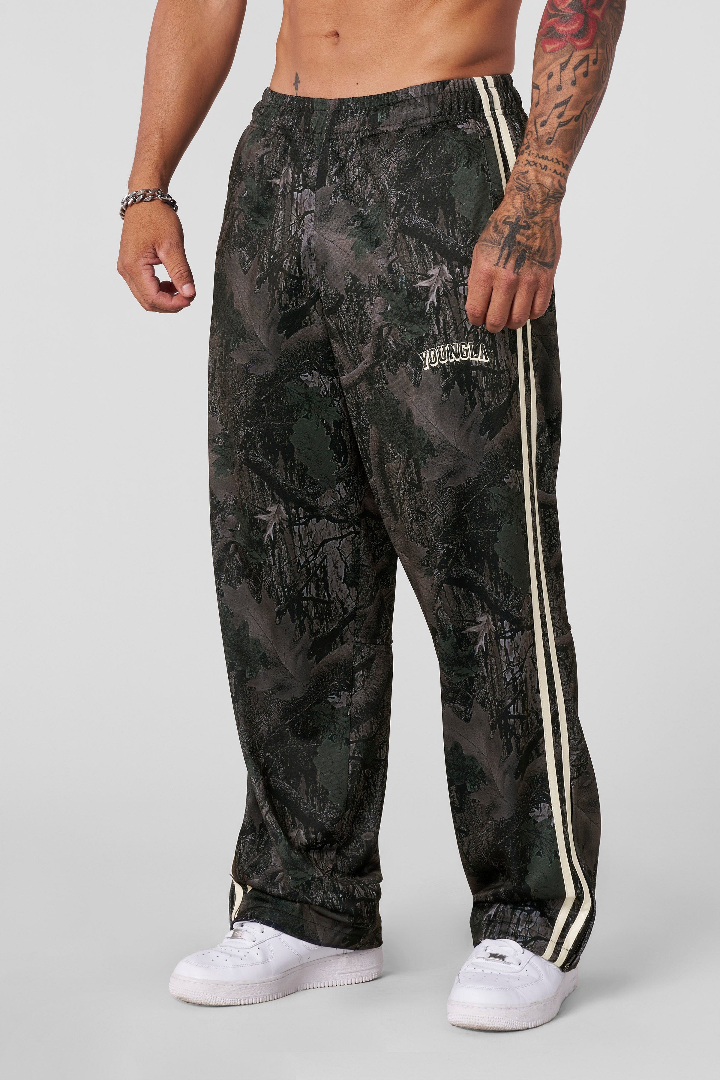 Track pants women edition in a retro clothing ensemble near the beach