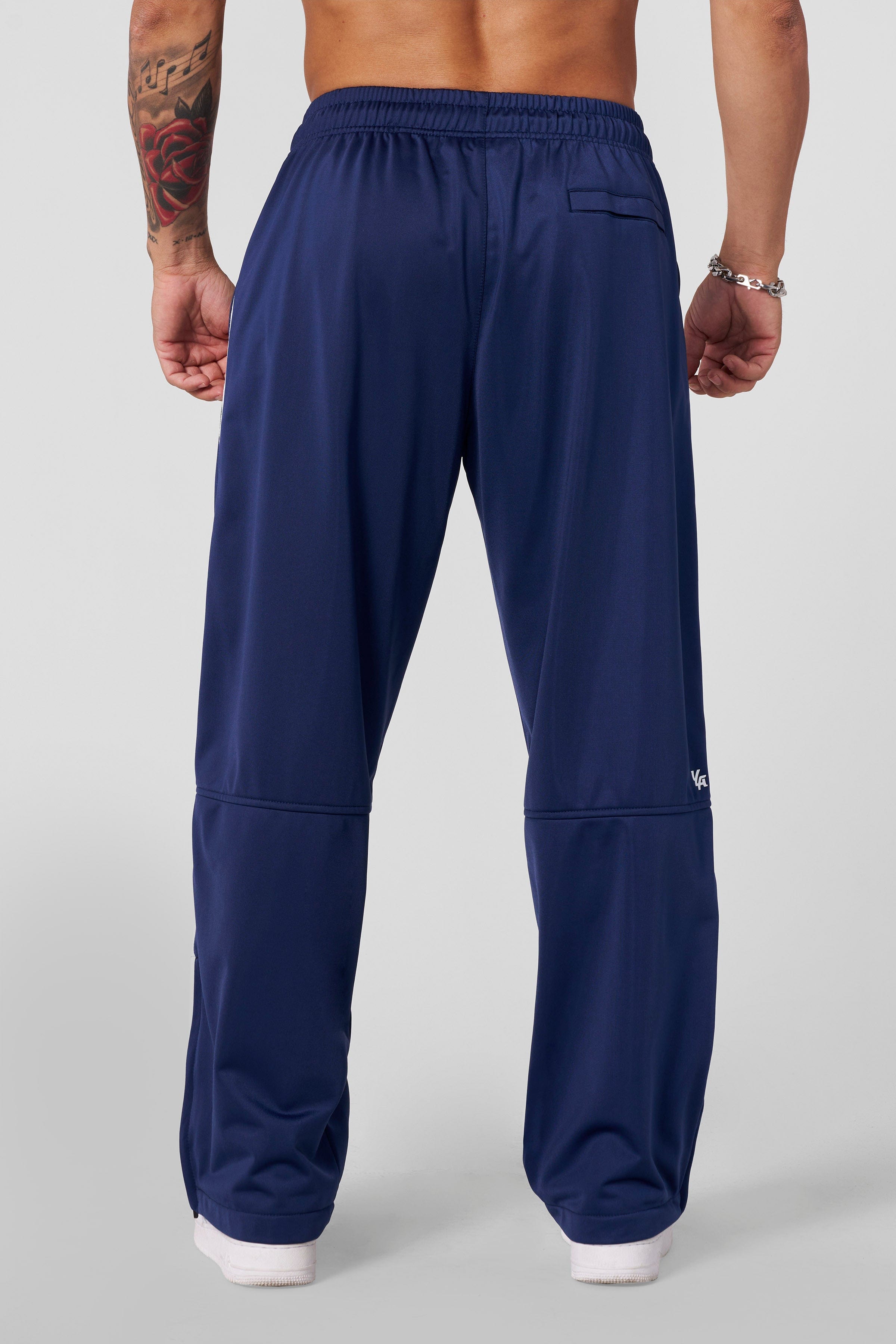 Track pants women edition in a retro clothing ensemble near the beach