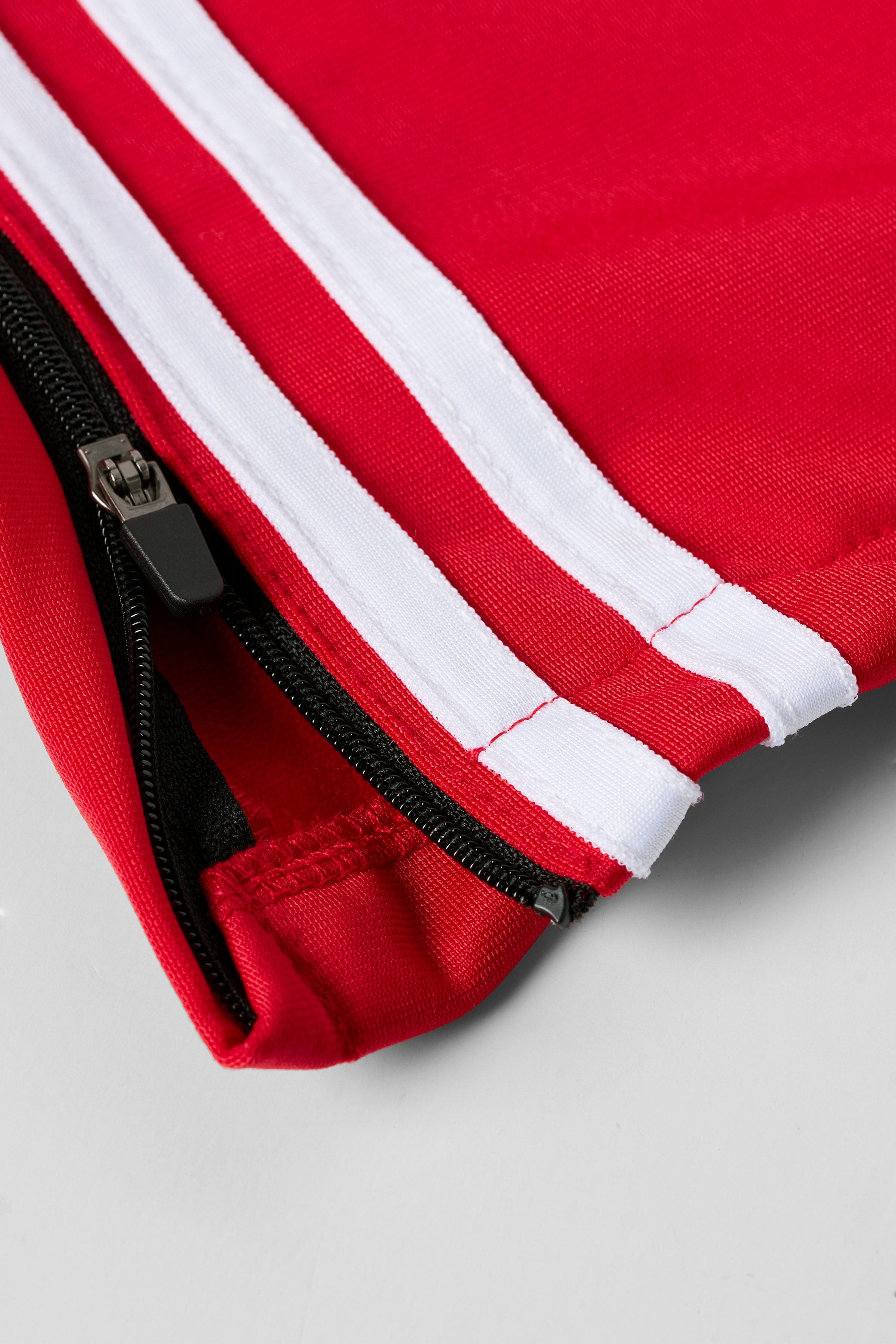 Loose-fit mens track pants styled with casual sneakers on city pavement