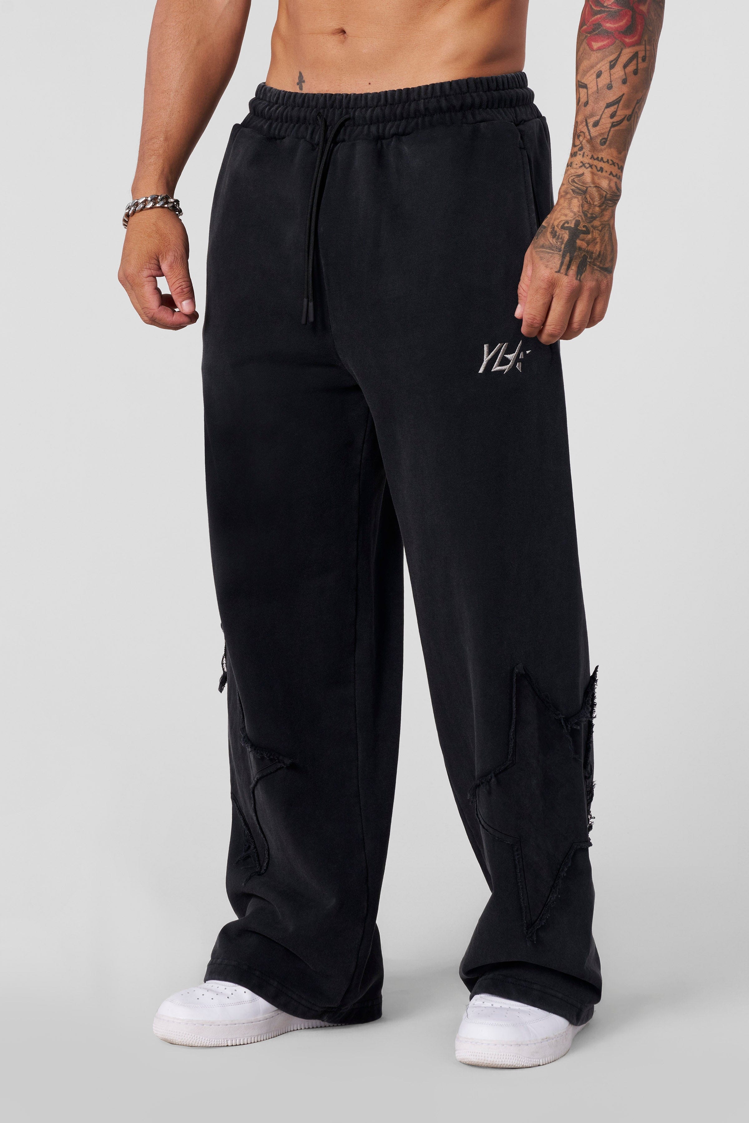 Model wearing Superstar Vintage Baggy Sweatpants in a streetwear style.