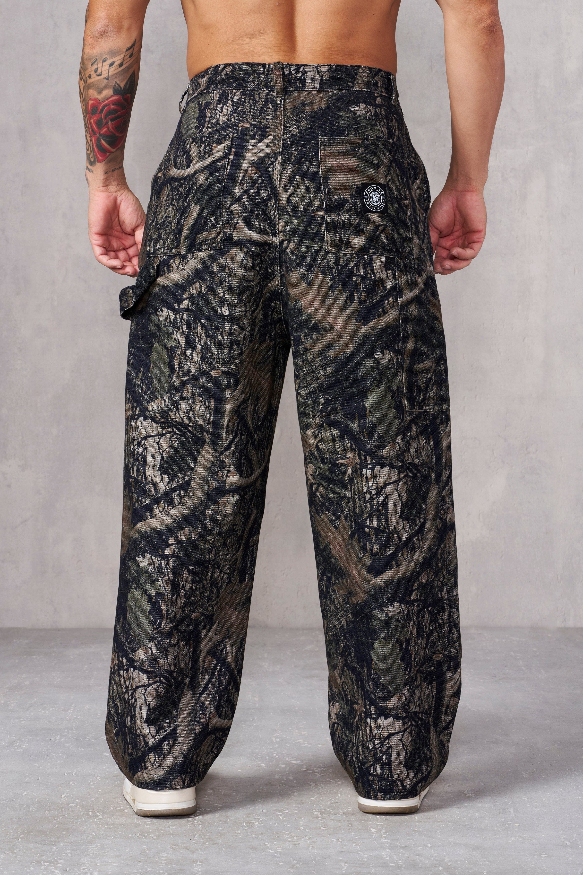 Front and back view of low-rise baggy jeans with camo print.
