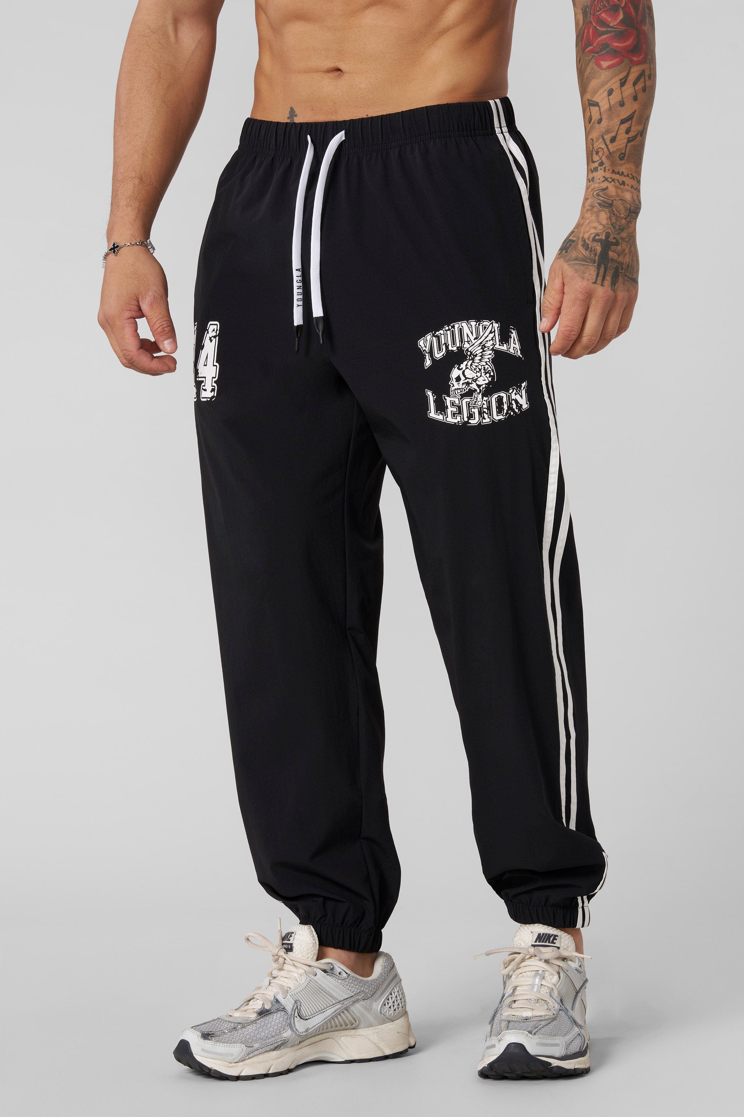 Close-up of joggers cuffed ankles, emphasizing modern athletic design.