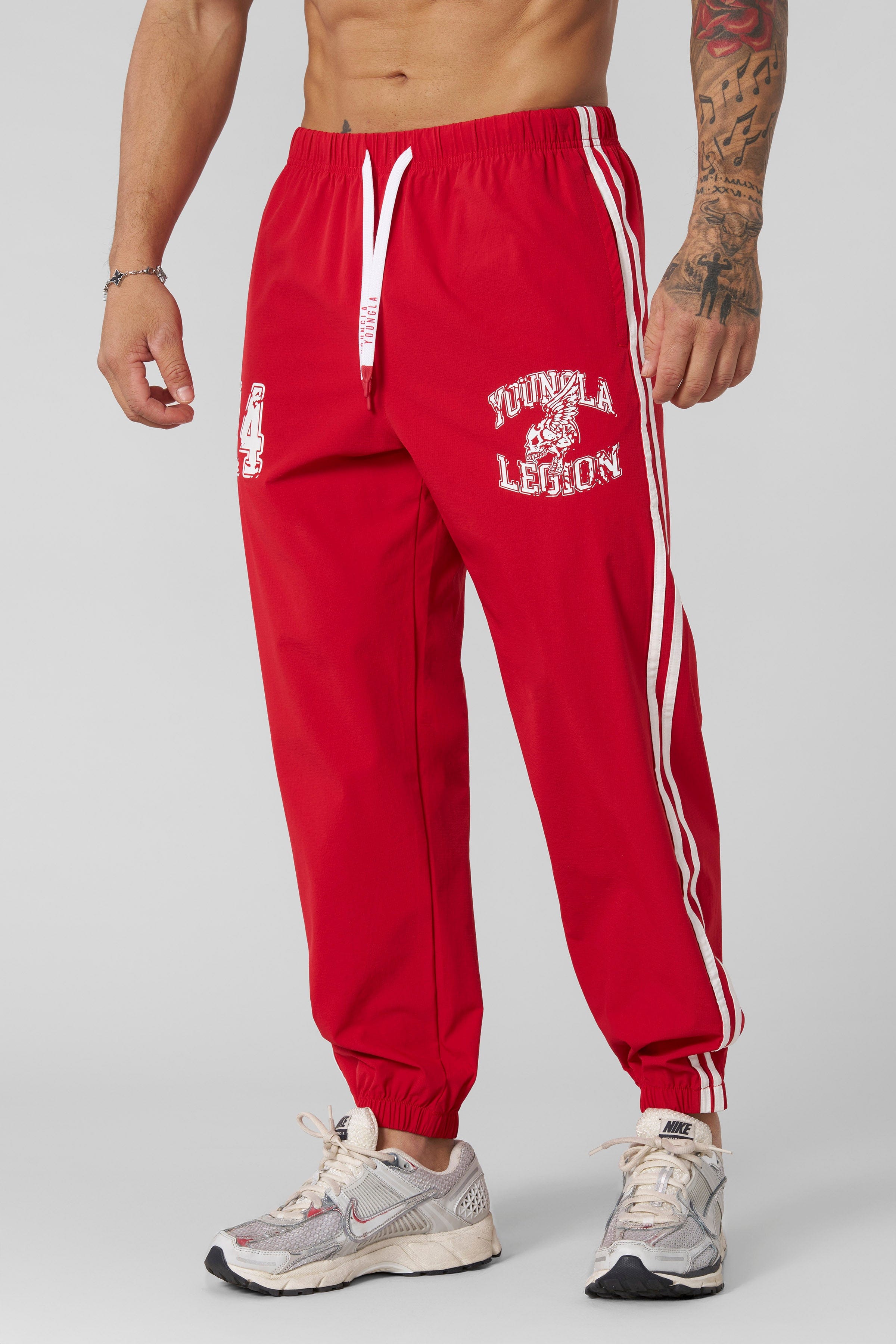 Side view of joggers with double side stripes, perfect for workouts.