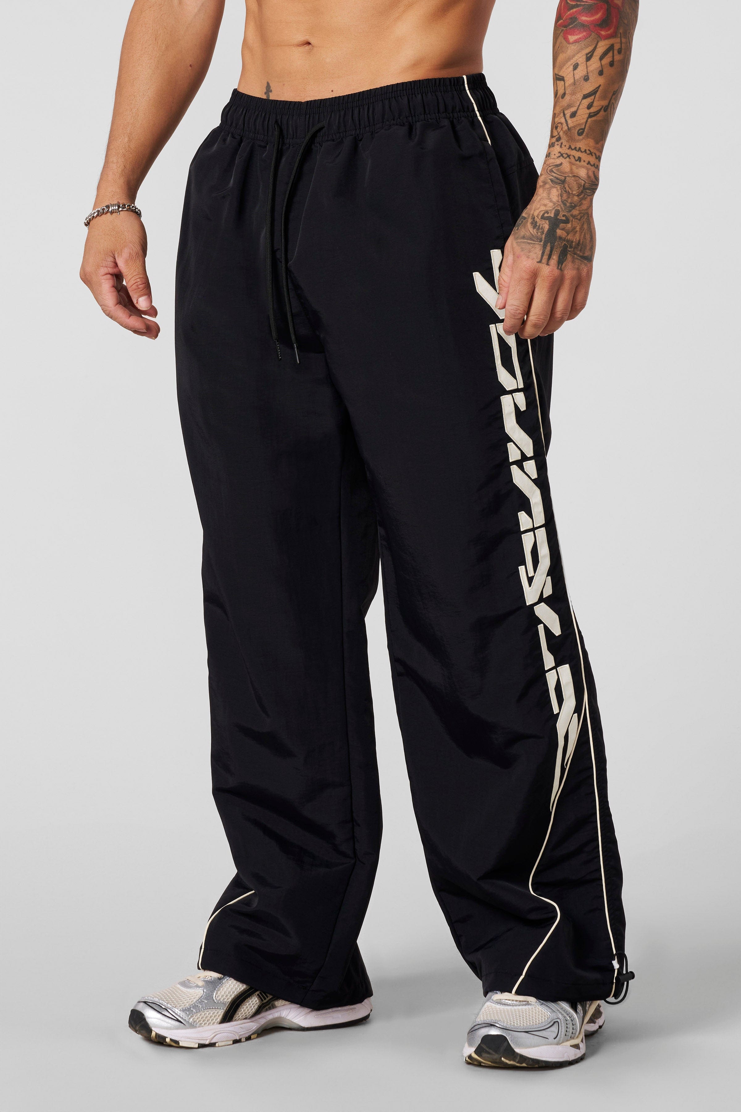Front view of Foundation Performance Track Pants showcasing the baggy fit.