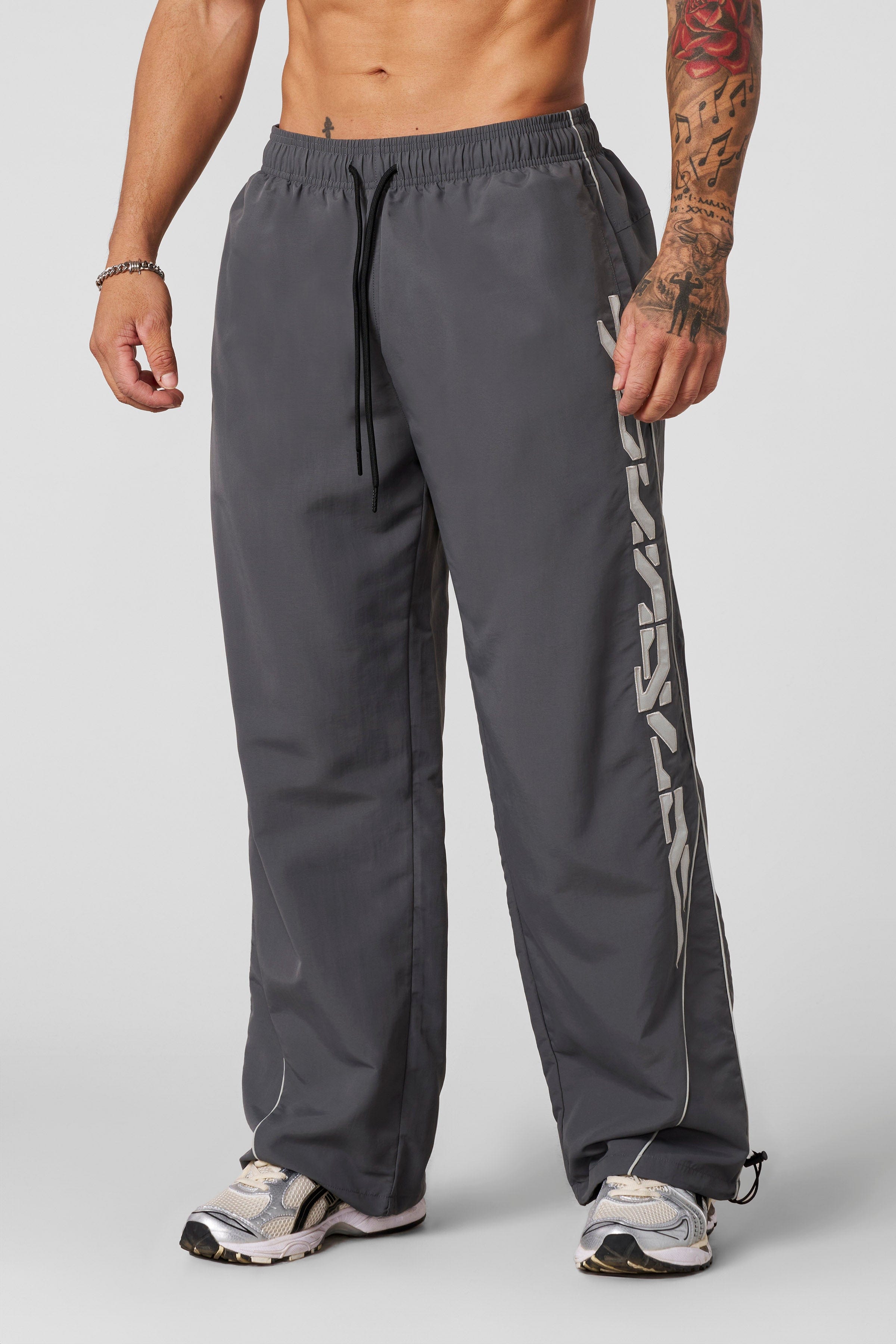Front view of Foundation Performance Track Pants showcasing the baggy fit.