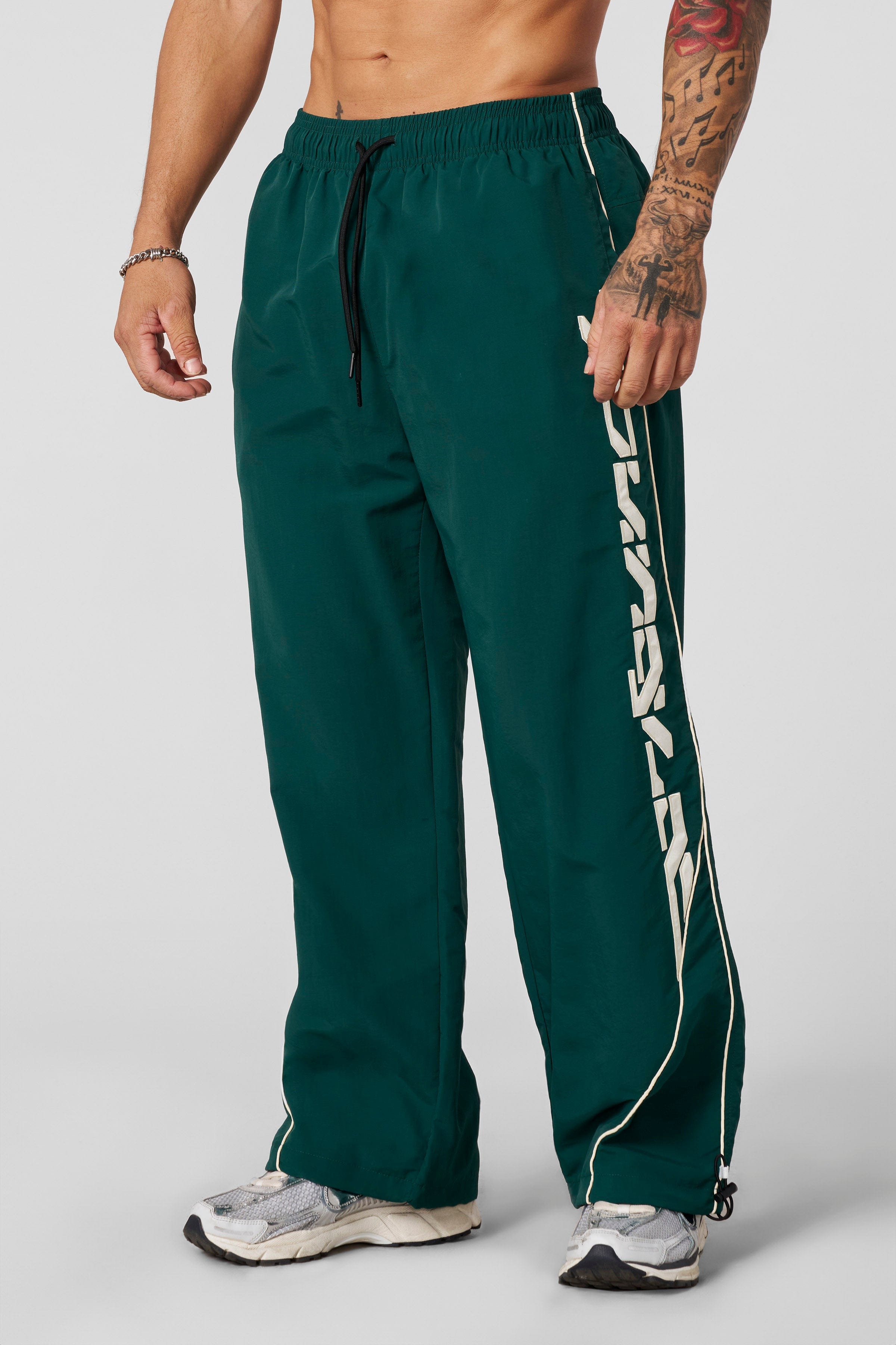 Front view of Foundation Performance Track Pants showcasing the baggy fit.