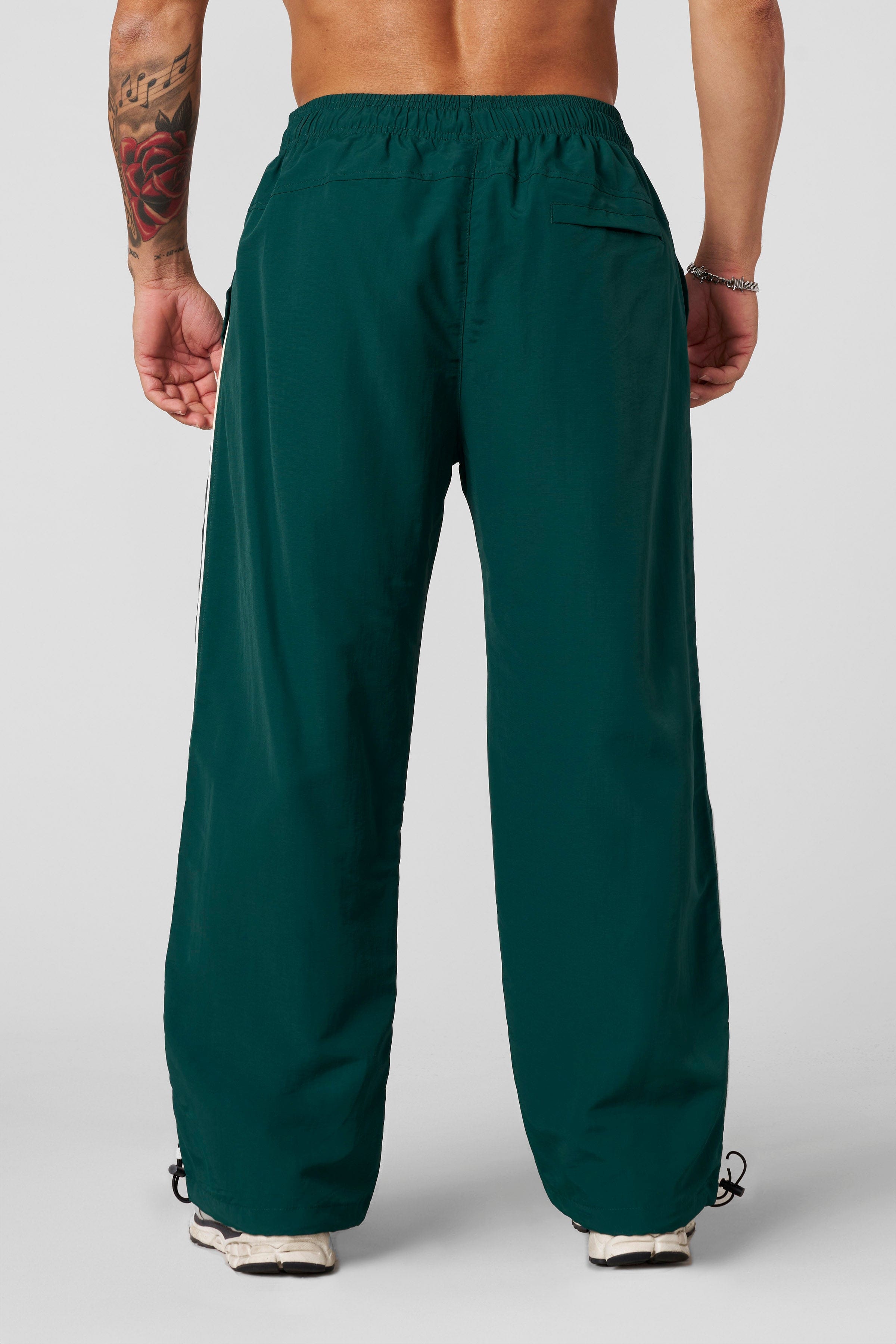 Front view of Foundation Performance Track Pants showcasing the baggy fit.