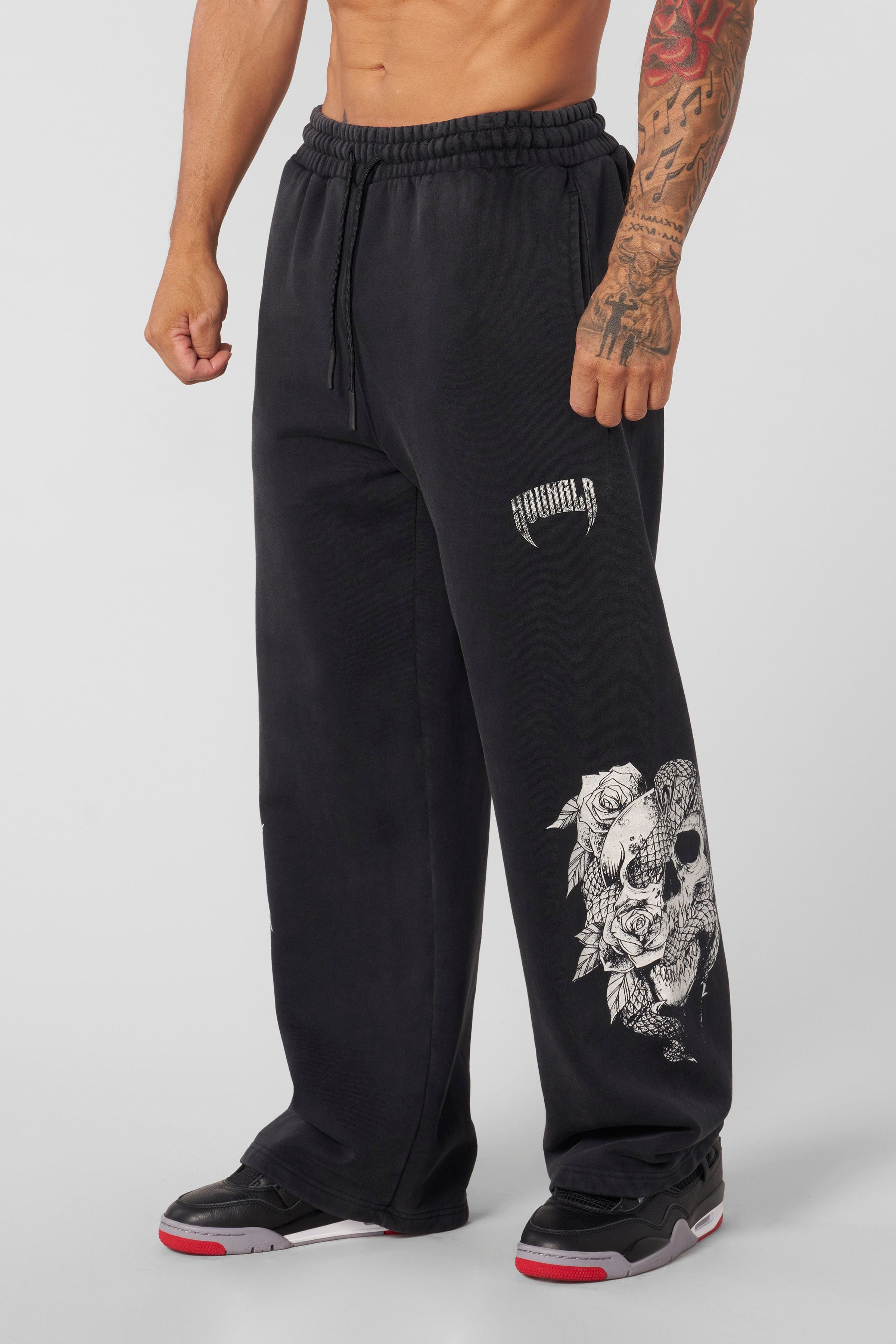Side view of graphic sweatpants showcasing skull and floral designs.