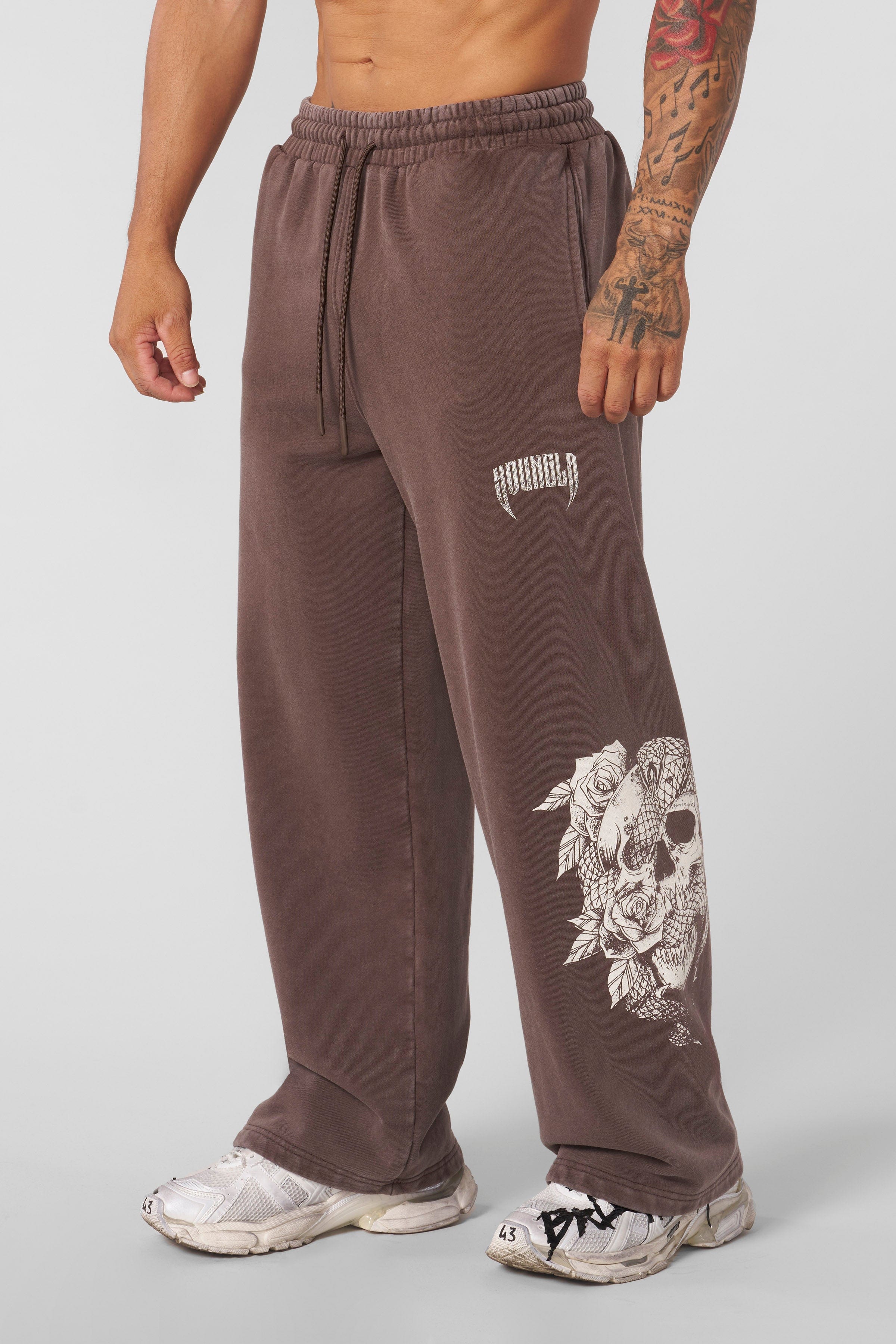 Side view of graphic sweatpants showcasing skull and floral designs.