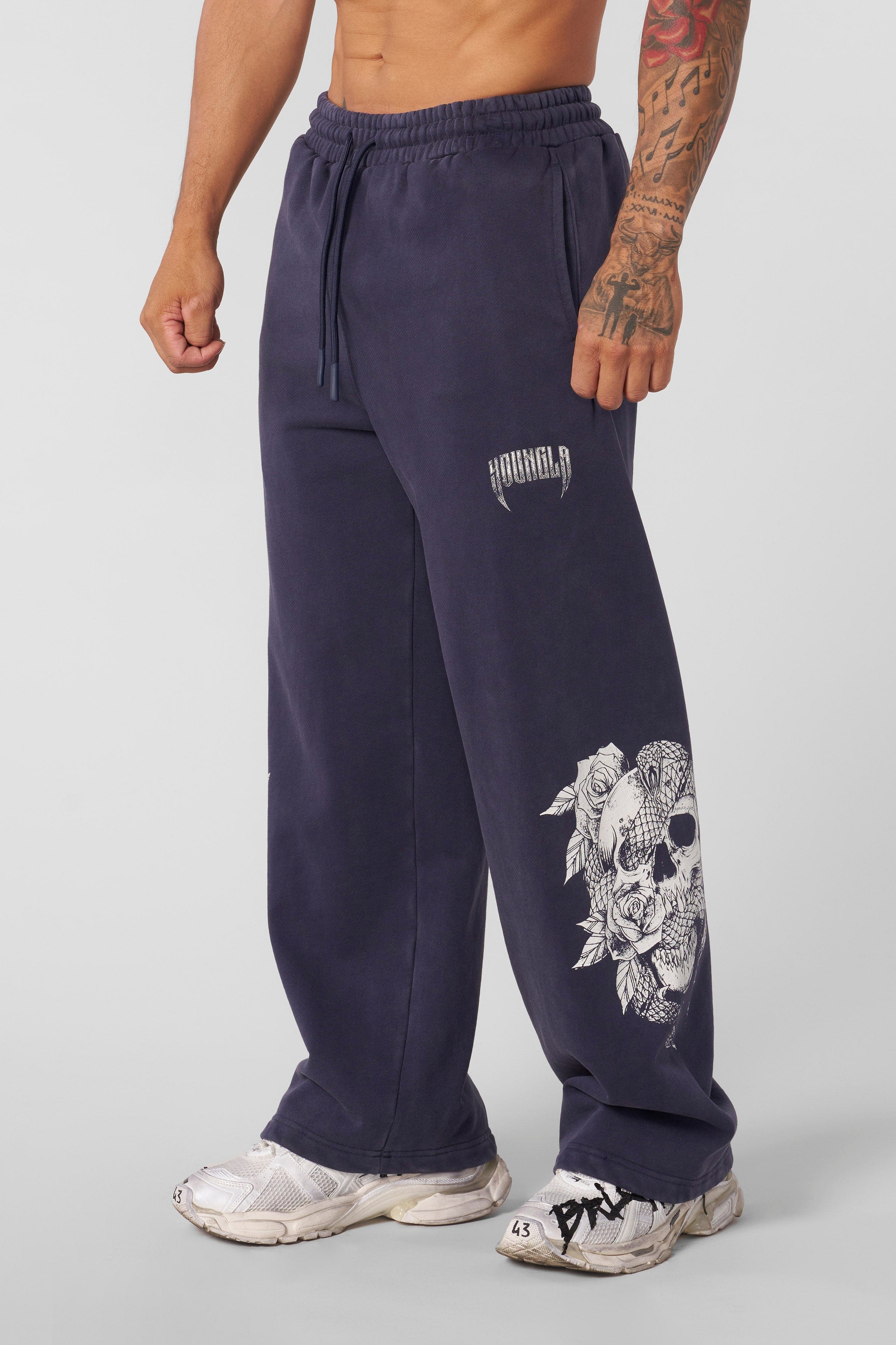 Model wearing baggy joggers in a casual setting.