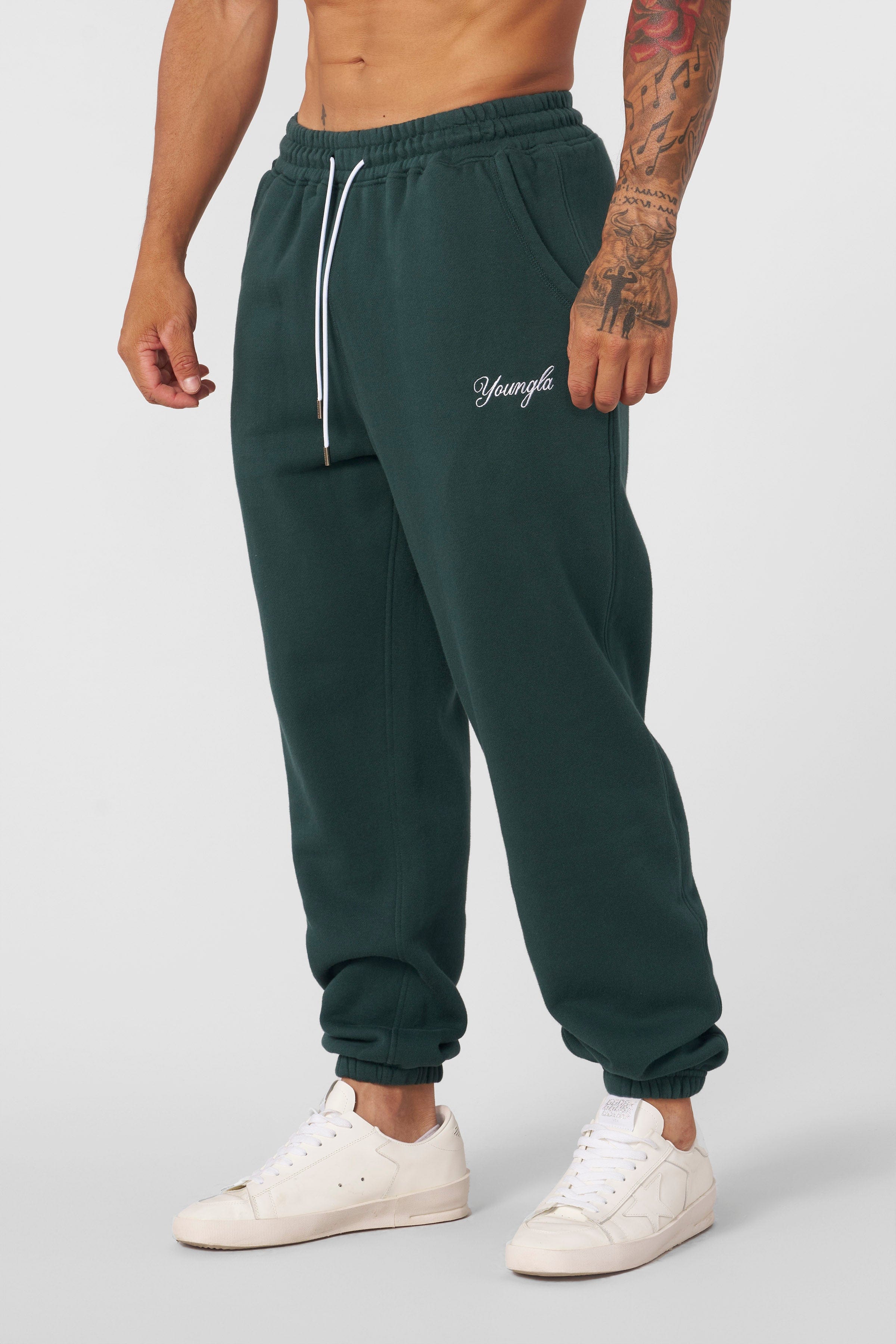 Side profile of model wearing loose-fit joggers in urban setting