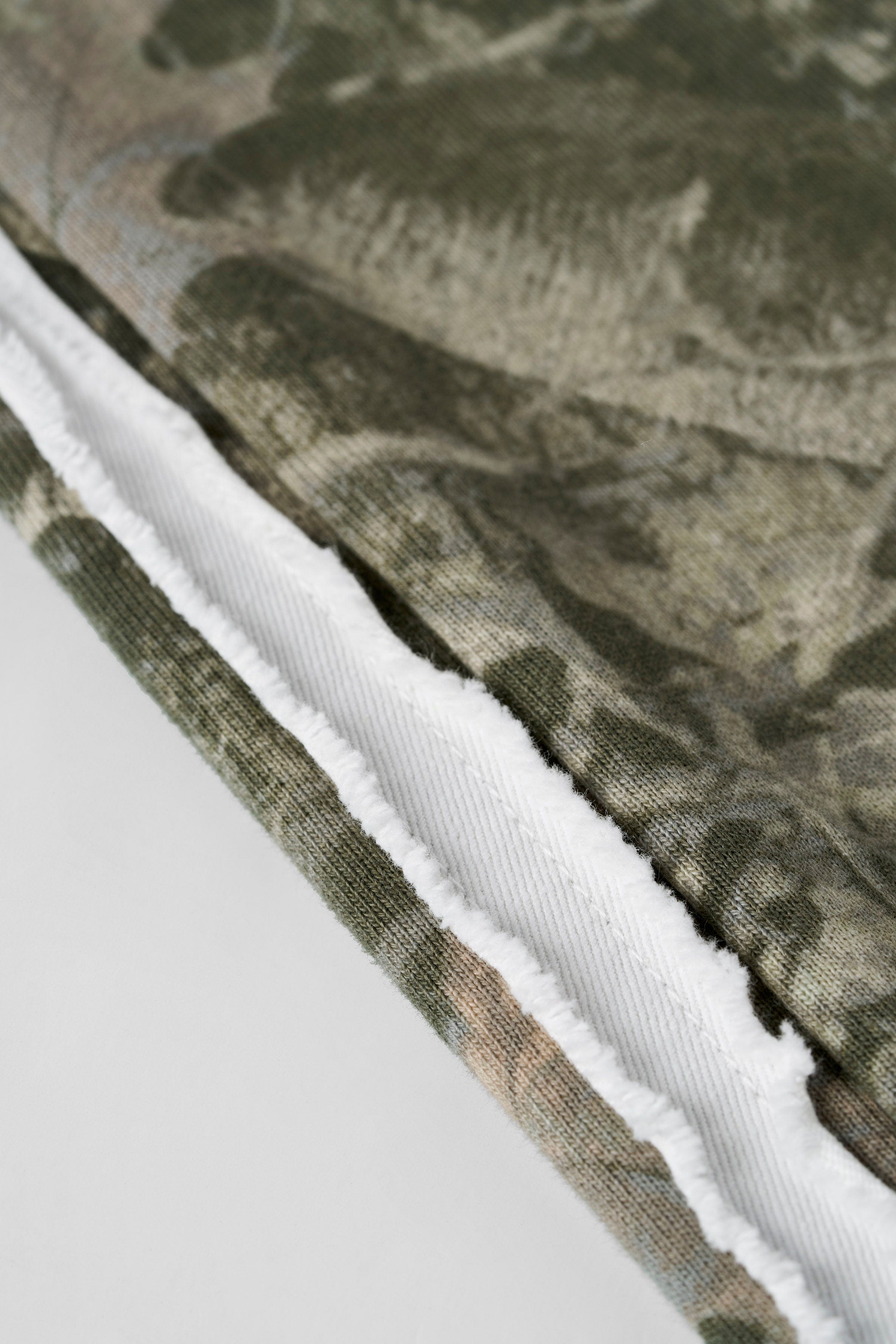 Close-up of striped sweatpants fabric texture and raw-cut detailing