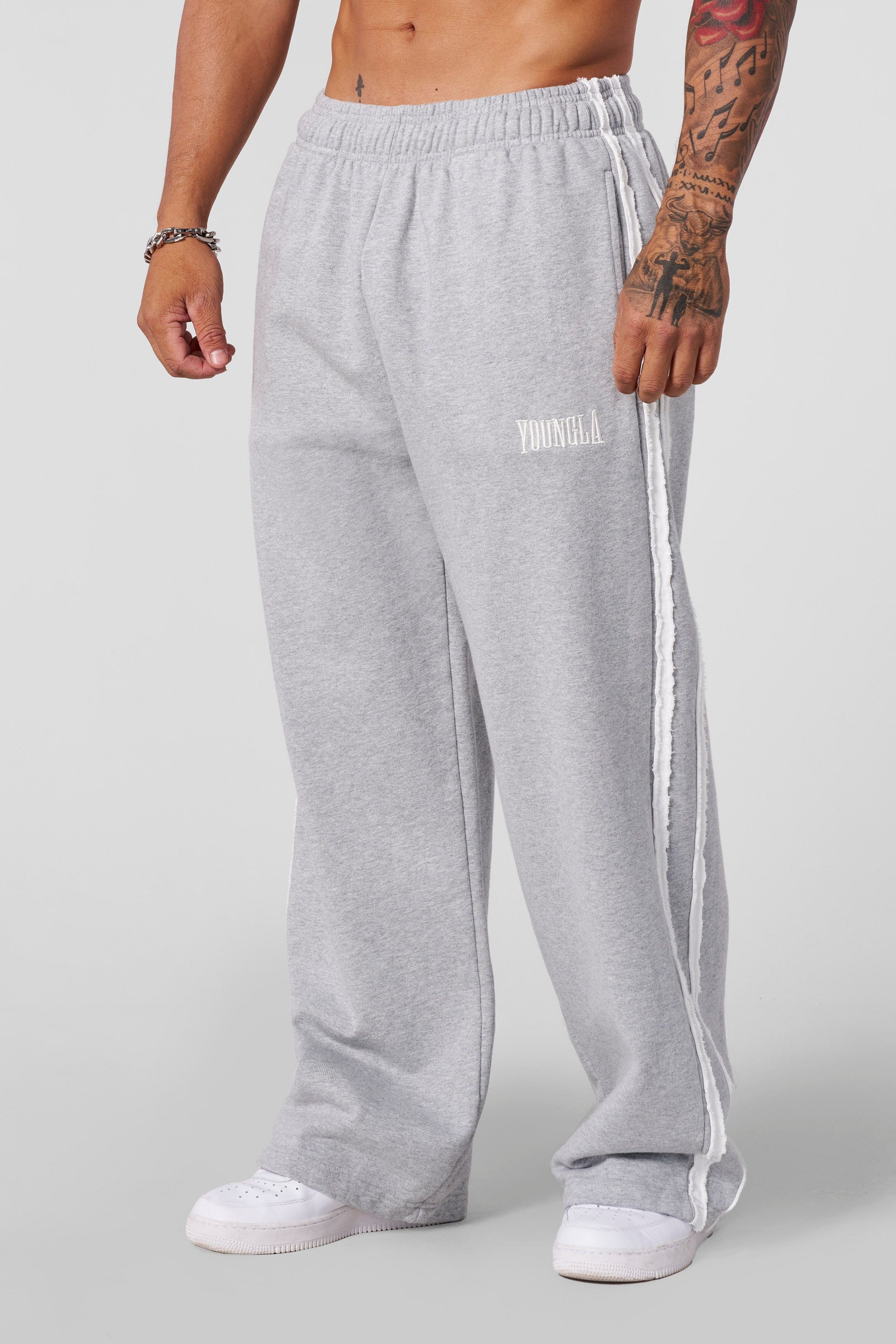 Close-up of striped sweatpants fabric texture and raw-cut detailing